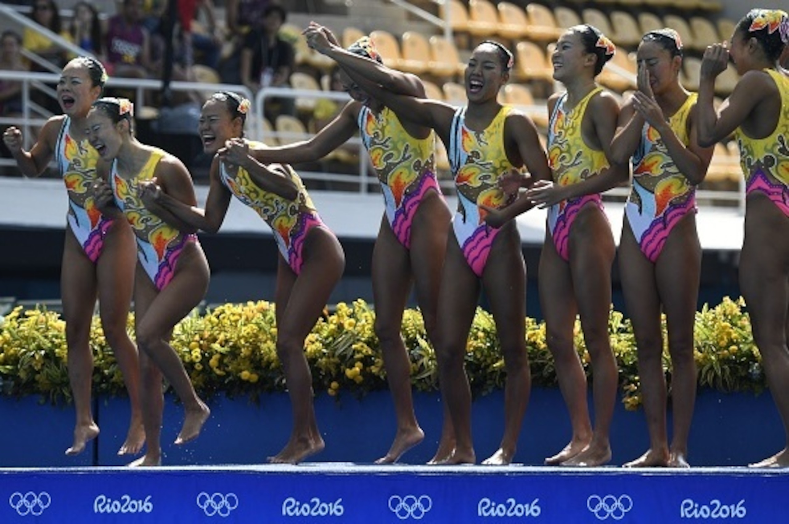 Team Japan waves after competing in the Teams Free Routine final during the synchronised swimming event at the Maria Lenk Aquatics at the Rio 2016 Olympic Games in Rio de Janeiro on August 19, 2016.  / AFP / CHRISTOPHE SIMON        (Photo credit should re