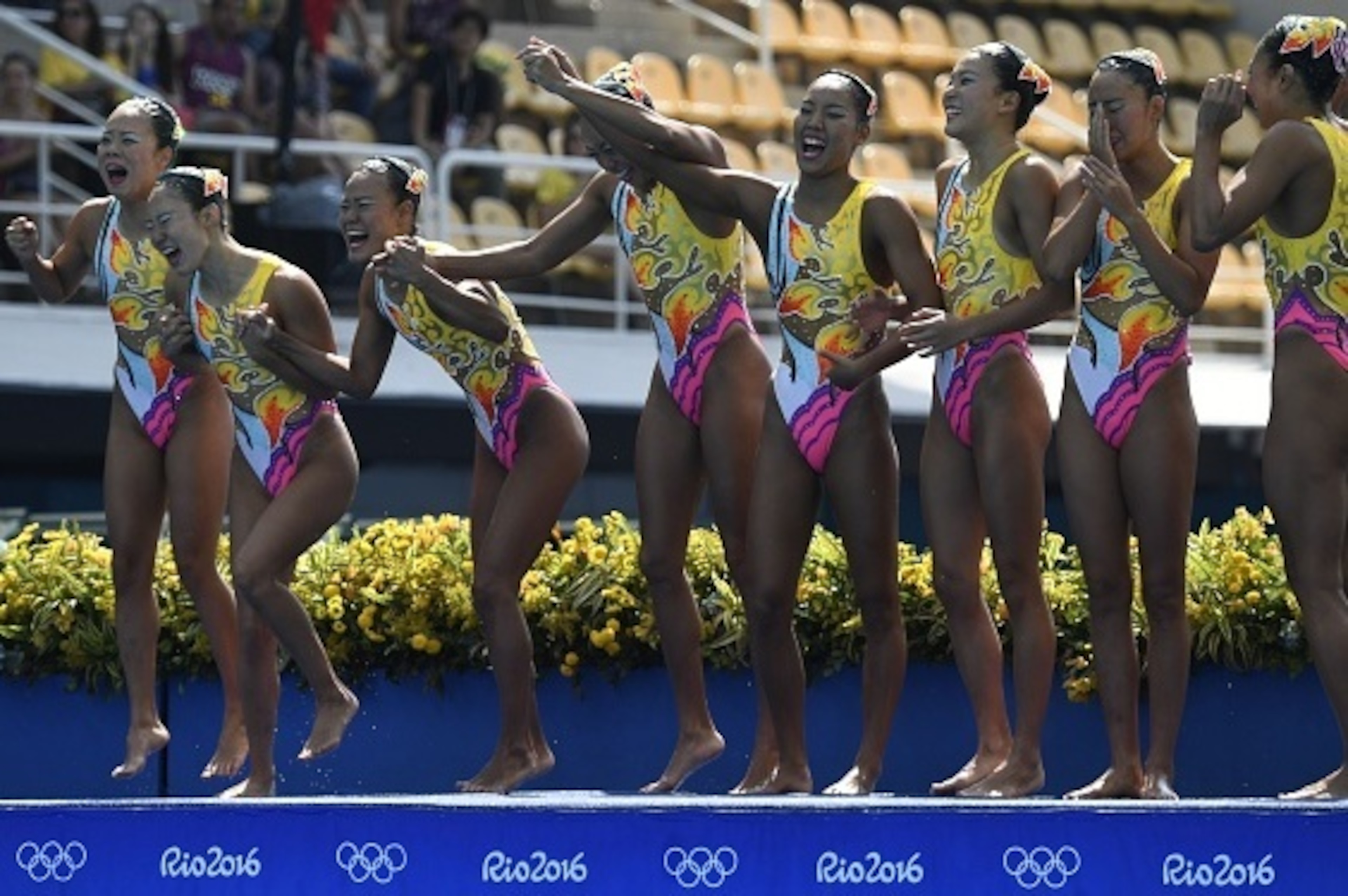 Team Japan waves after competing in the Teams Free Routine final during the synchronised swimming event at the Maria Lenk Aquatics at the Rio 2016 Olympic Games in Rio de Janeiro on August 19, 2016.  / AFP / CHRISTOPHE SIMON        (Photo credit should re