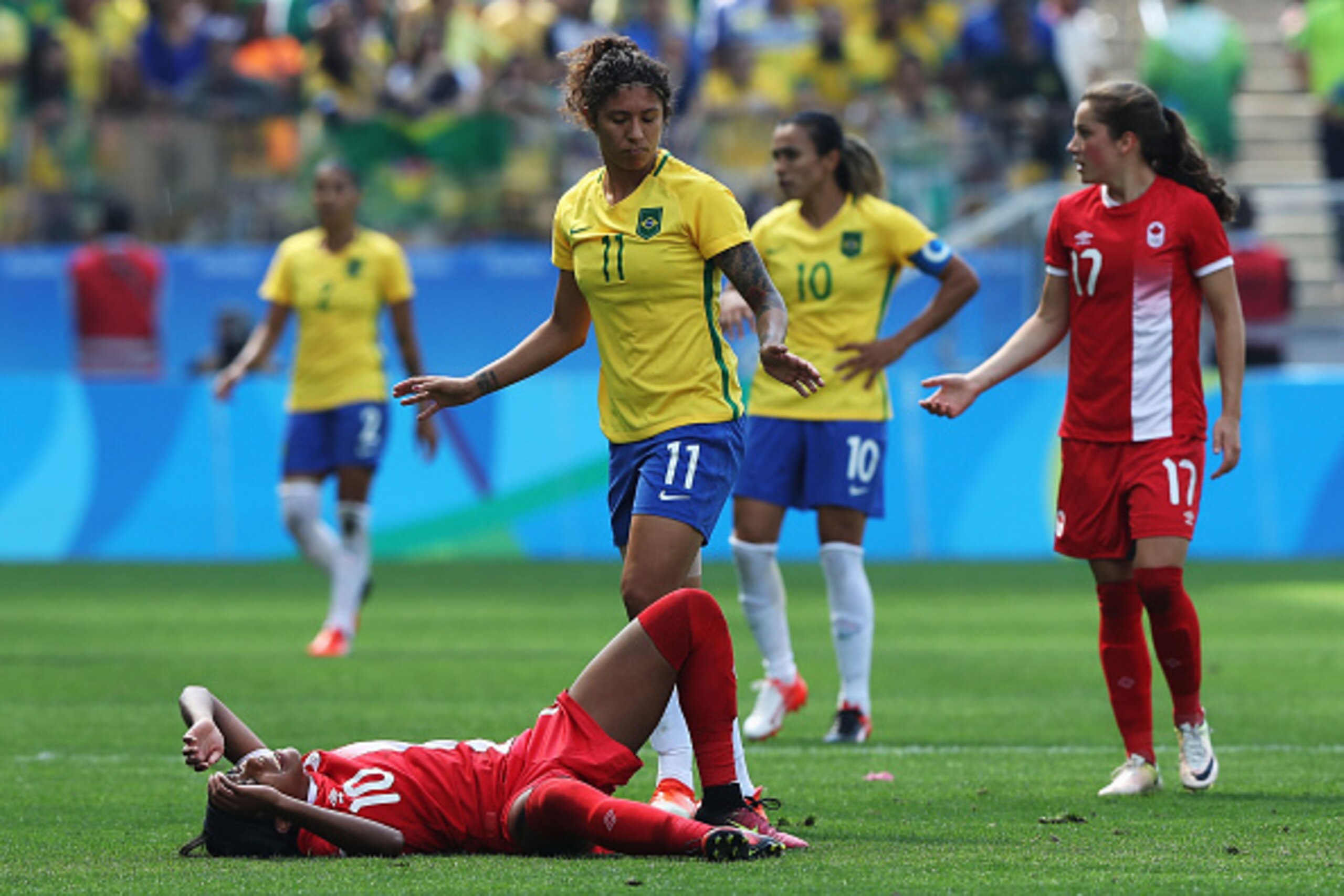 SAO PAULO, BRAZIL - AUGUST 19:  Ashley Lawrence of Canada stays down after a tackle during the Women's Olympic Football Bronze Medal match between Brazil and Canada at Arena Corinthians on August 19, 2016 in Sao Paulo, Brazil.  (Photo by Alexandre Schneid
