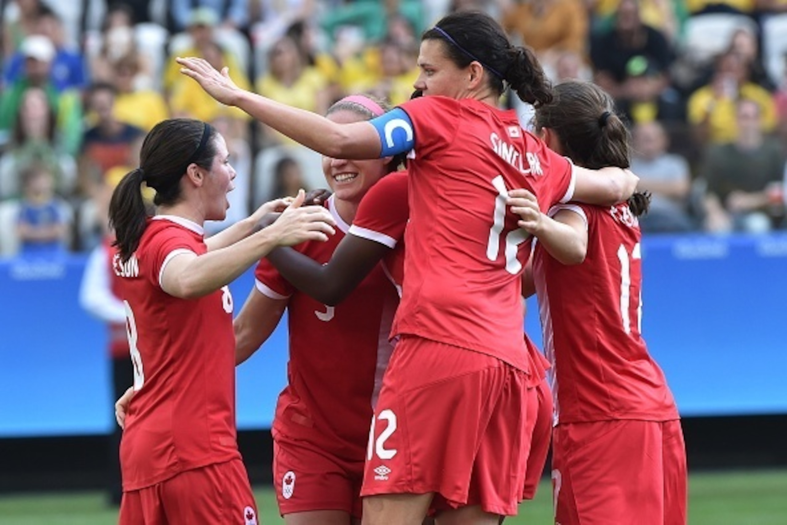 Deanne Rose (C) of Canada celebrates her goal with teammates scored against Brazil during the Rio 2016 Olympic Games women's bronze medal football match between Brazil vs Canada, at the Arena Corinthians Stadium in Sao Paulo, Brazil on August 19, 2016 / A
