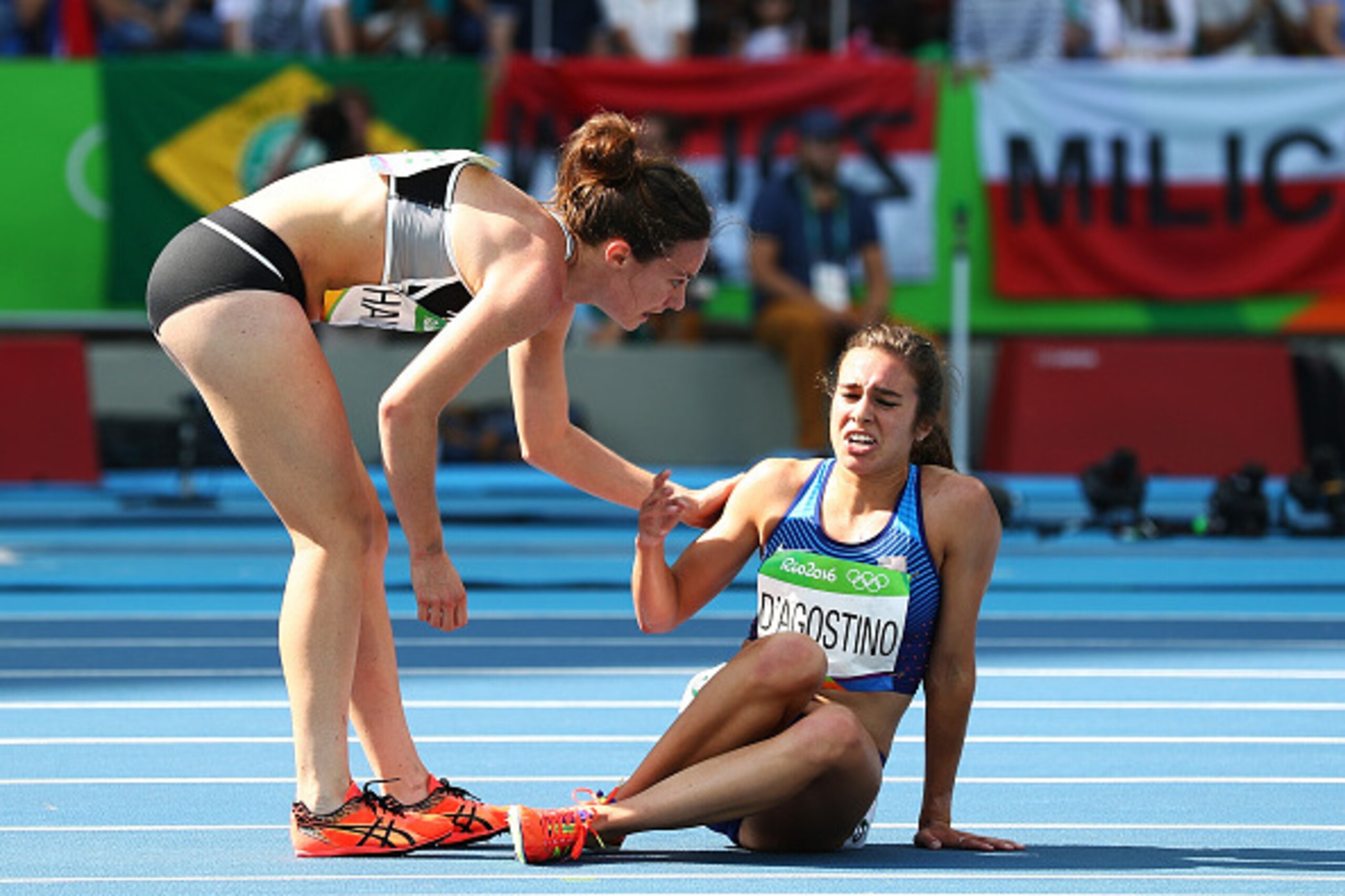 RIO DE JANEIRO, BRAZIL - AUGUST 16:  Abbey D'Agostino of the United States (R) is assisted by Nikki Hamblin of New Zealand after a collision during the Women's 5000m Round 1 - Heat 2 on Day 11 of the Rio 2016 Olympic Games at the Olympic Stadium on August