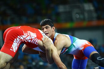 RIO DE JANEIRO, BRAZIL - AUGUST 19:  Hassan Aliazam Yazdanicharati of Iran  competes against  Soner Demirtas of Turkey during the Men's Freestyle 74kg Weightlifting quarter final contest on Day 14 of the Rio 2016 Olympic Games at Carioca Arena 2 on August
