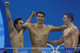 TOPSHOT - (from R) USA's Ryan Murphy, Michael Phelps, Cody Miller celebrate after the Men's swimming 4 x 100m Medley Relay Final at the Rio 2016 Olympic Games at the Olympic Aquatics Stadium in Rio de Janeiro on August 13, 2016.   / AFP / Odd Andersen    