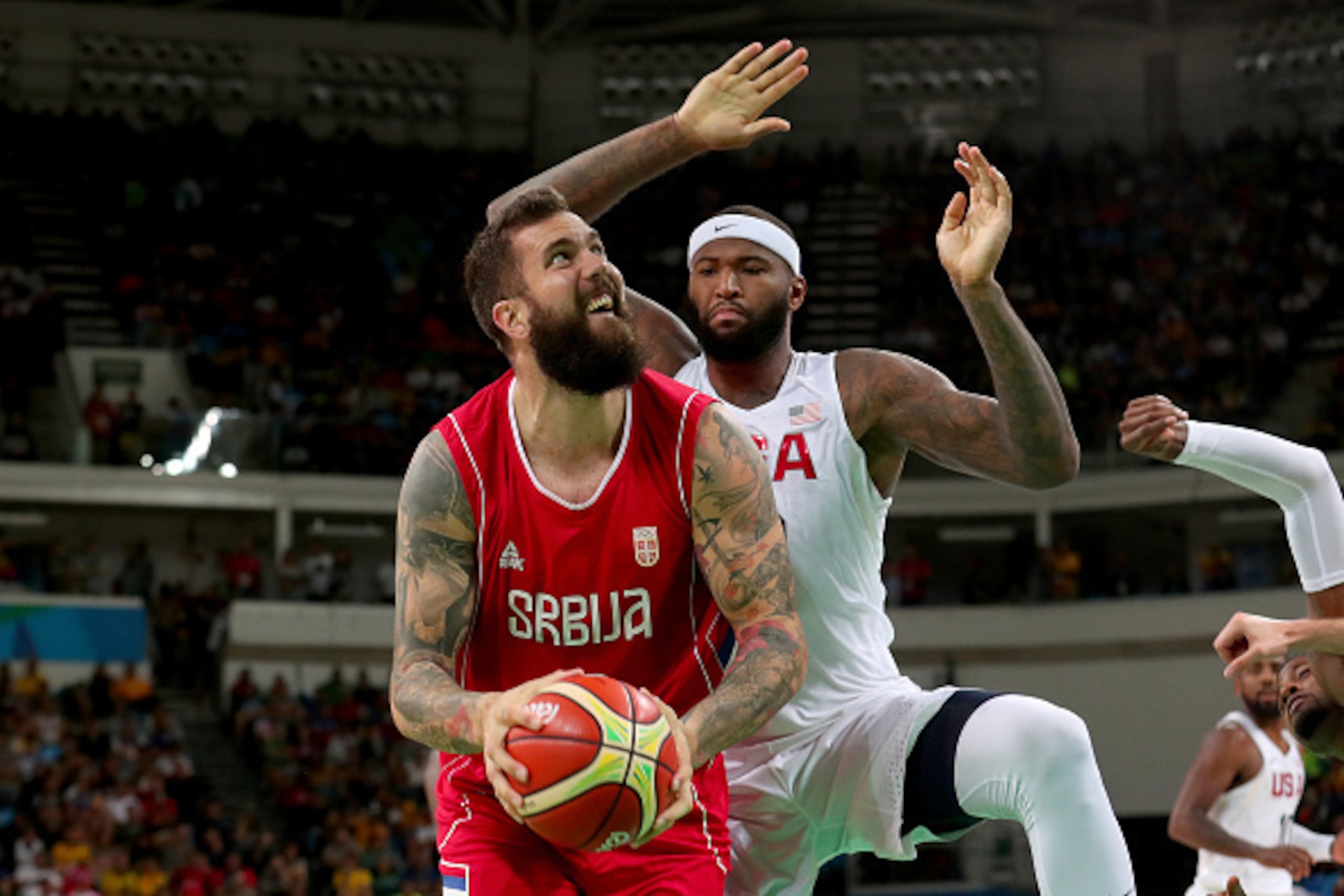 RIO DE JANEIRO, BRAZIL - AUGUST 12: Miroslav Raduljica #13 of Serbia goes to the basket against Demarcus Cousins #12 of United States in the Men's Preliminary Round Group A match on Day 7 of the Rio 2016 Olympic Games at Carioca Arena 1 on August 12, 2016