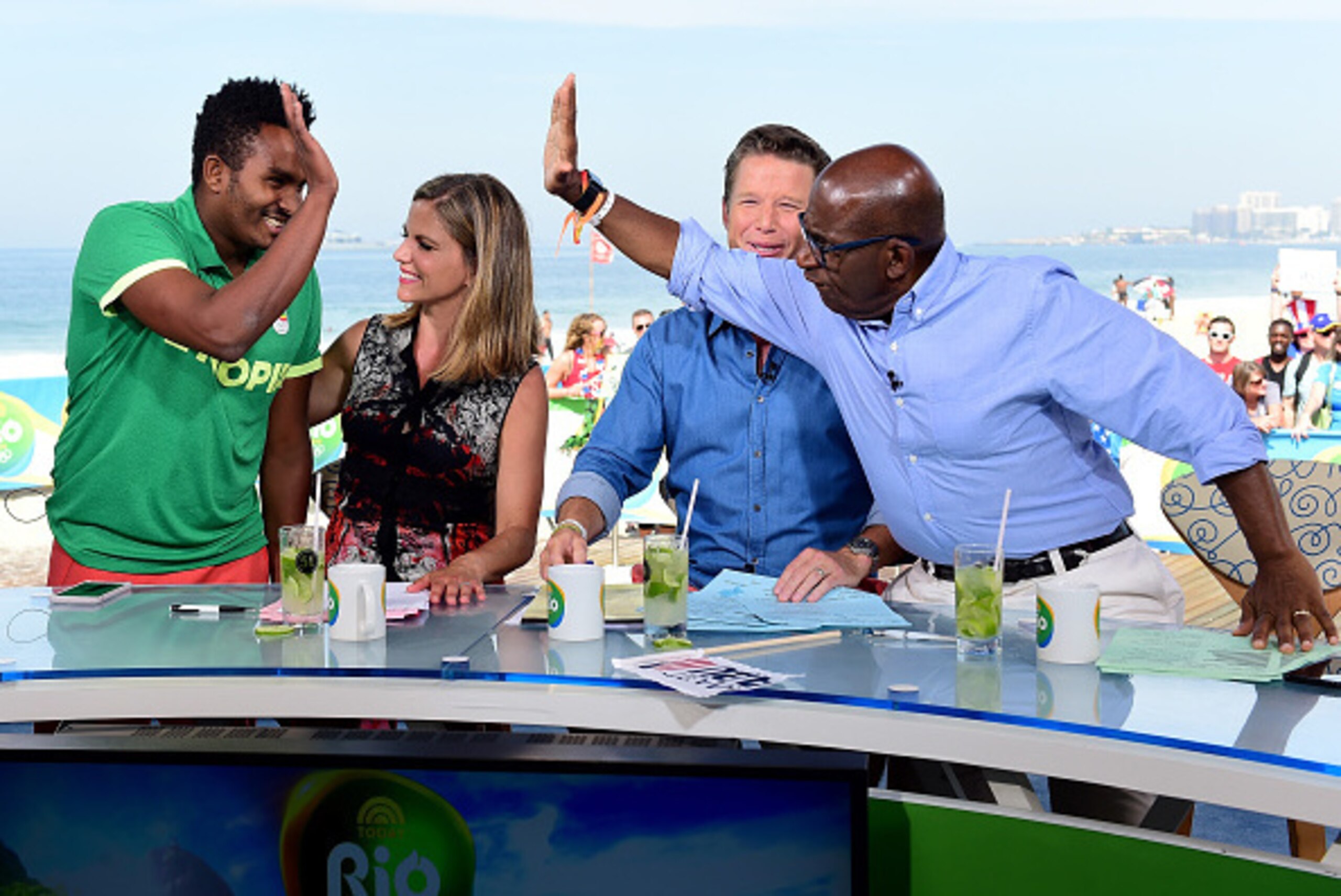 RIO DE JANEIRO, BRAZIL - AUGUST 16:  (BROADCAST - OUT) Robel Kiros Habte of Ethiopia receives a high five from Al Roker with Natalie Morales, Billy Bush on the Today show set on Copacabana Beach on August 16, 2016 in Rio de Janeiro, Brazil.  (Photo by Har