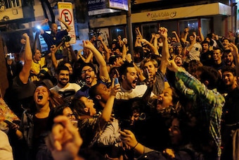Fans celebrate in the street outside a bar in Copacabana.