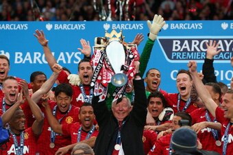 MANCHESTER, ENGLAND - MAY 12:  Manchester United Manager Sir Alex Ferguson lifts the Premier League trophy following the Barclays Premier League match between Manchester United and Swansea City at Old Trafford on May 12, 2013 in Manchester, England.  (Pho
