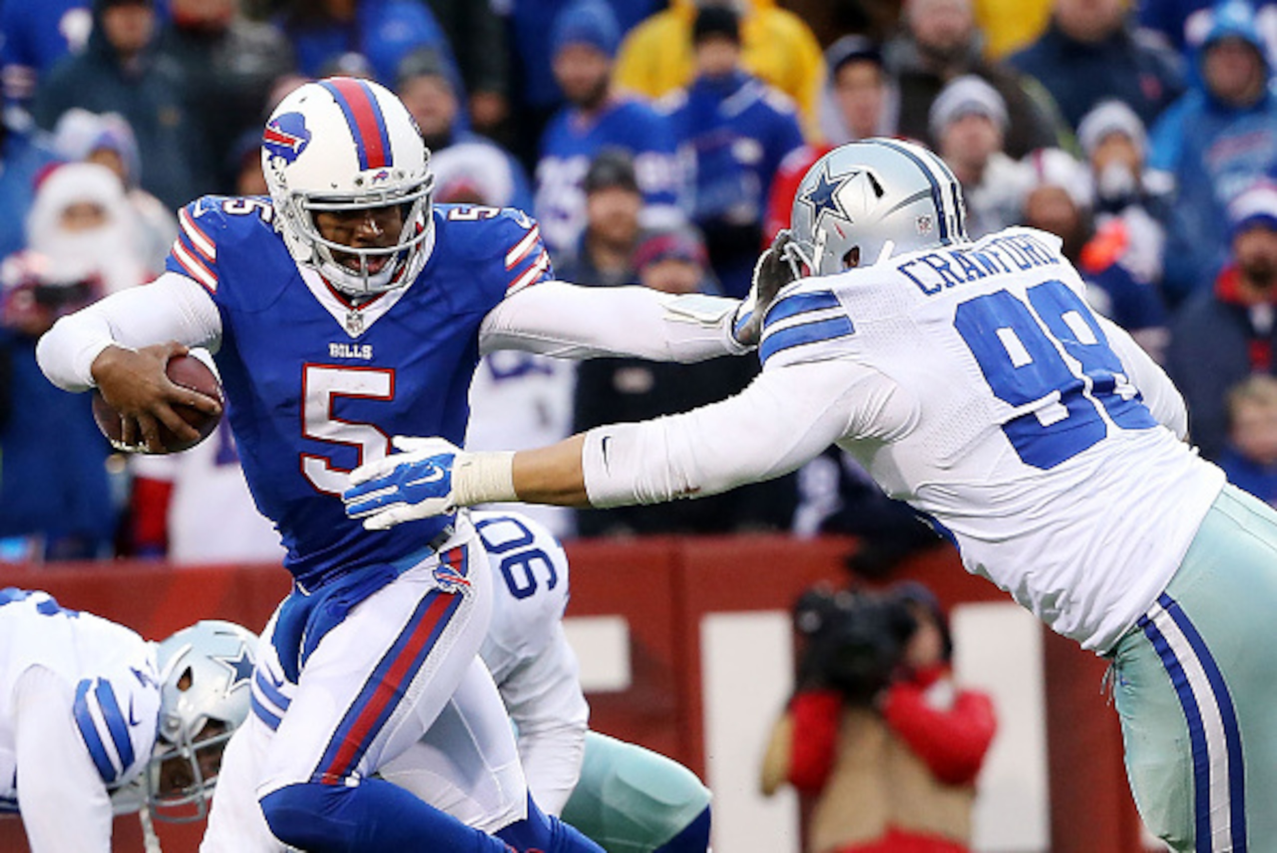 ORCHARD PARK, NY - DECEMBER 27:   Tyrod Taylor #5 of the Buffalo Bills pushes off on the facemask of  Tyrone Crawford #98 of the Dallas Cowboys during the second half at Ralph Wilson Stadium on December 27, 2015 in Orchard Park, New York.  (Photo by Tom S
