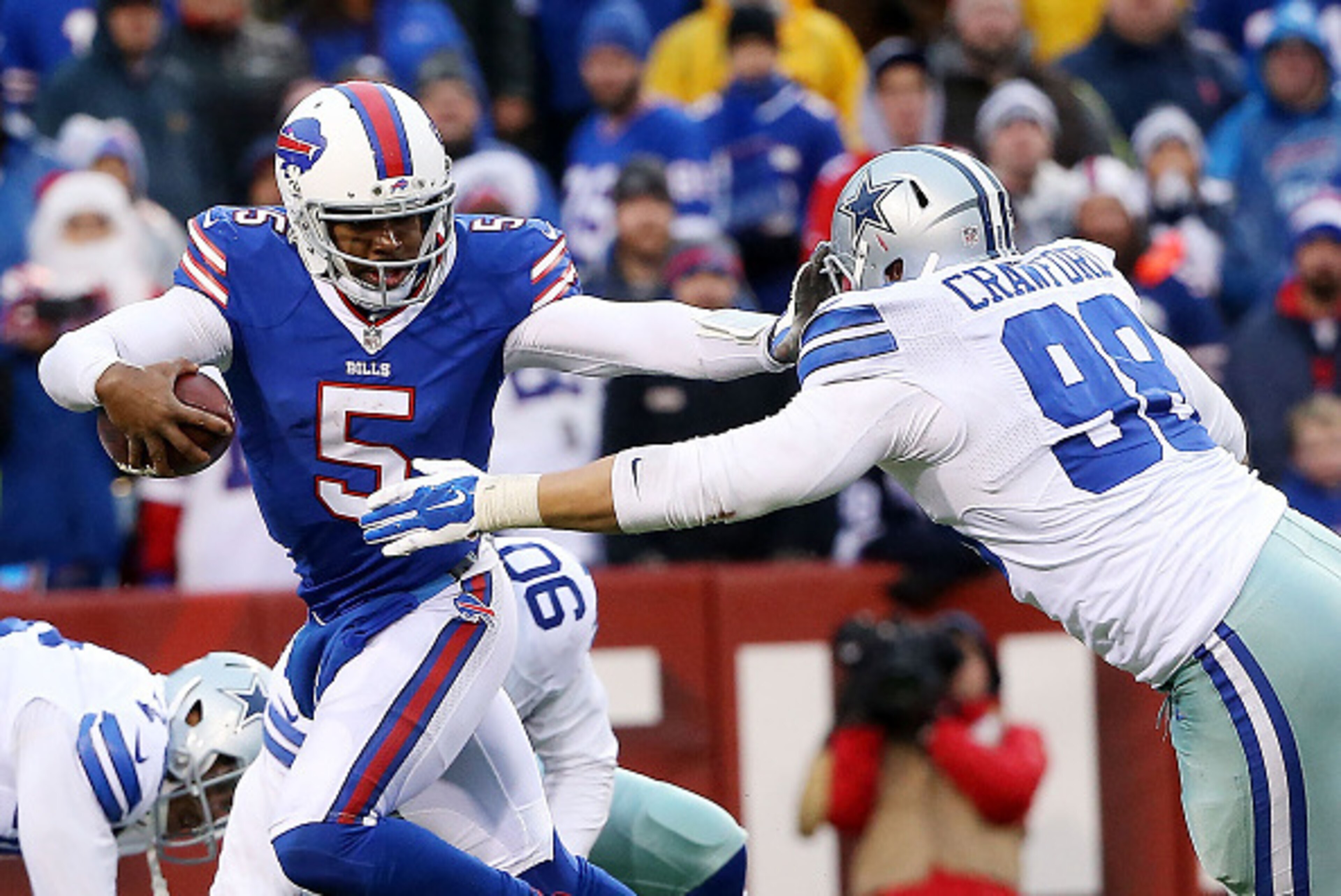 ORCHARD PARK, NY - DECEMBER 27:   Tyrod Taylor #5 of the Buffalo Bills pushes off on the facemask of  Tyrone Crawford #98 of the Dallas Cowboys during the second half at Ralph Wilson Stadium on December 27, 2015 in Orchard Park, New York.  (Photo by Tom S