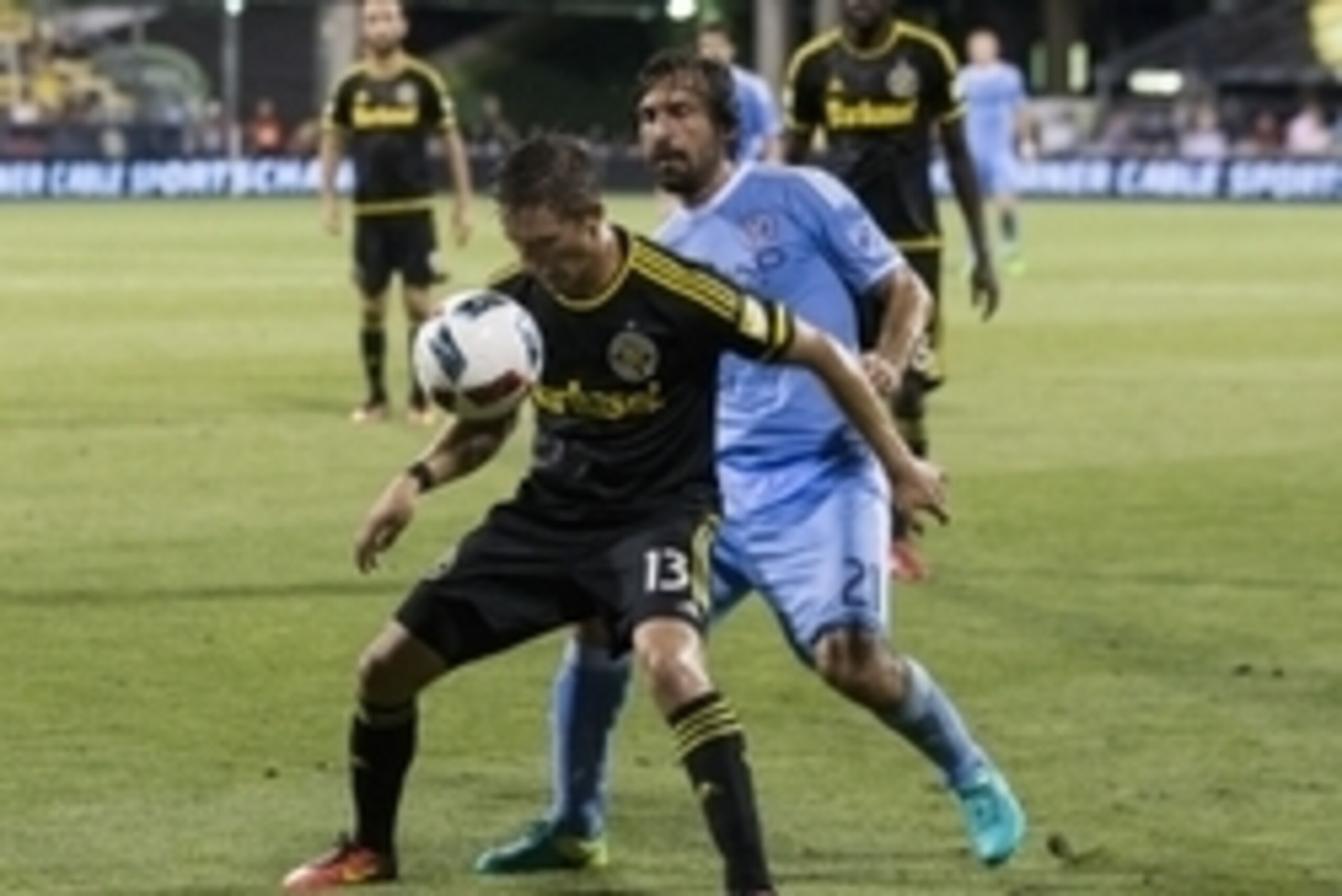 Aug 13, 2016; Columbus, OH, USA; Columbus Crew SC midfielder Ethan Finlay (13) plays the ball with New York City FC midfielder Andrea Pirlo (21) at his back at MAPFRE Stadium. Mandatory Credit: Greg Bartram-USA TODAY Sports