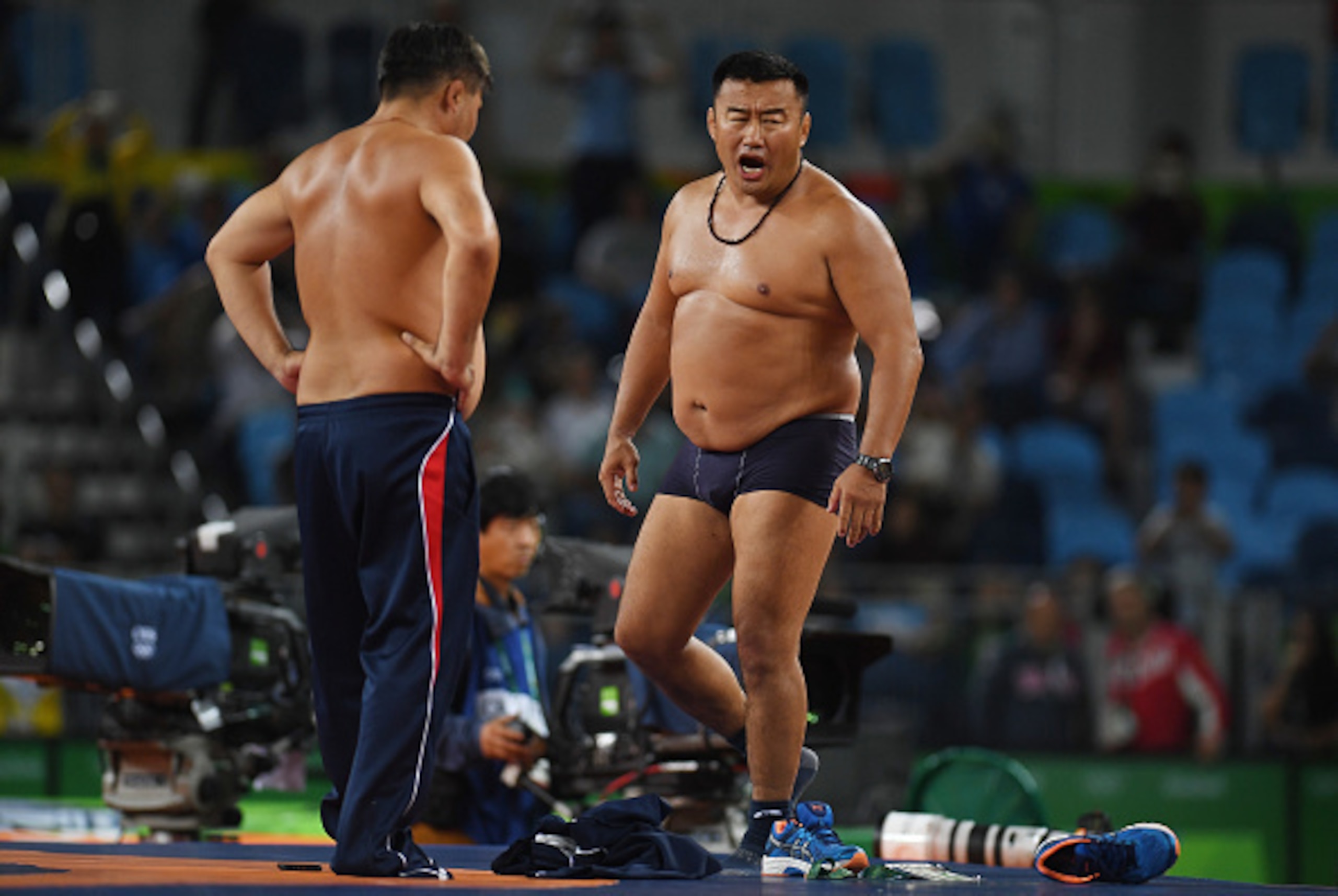 RIO DE JANEIRO, BRAZIL - AUGUST 21:  Mongolias coaches protest the judges decision after Mandakhnaran Ganzorig (red) of Mongolia is defeated by Ikhtiyor Navruzov (blue) of Uzbekistan in the Men's Freestyle 65kg Bronze match against  on Day 16 of the Rio 2