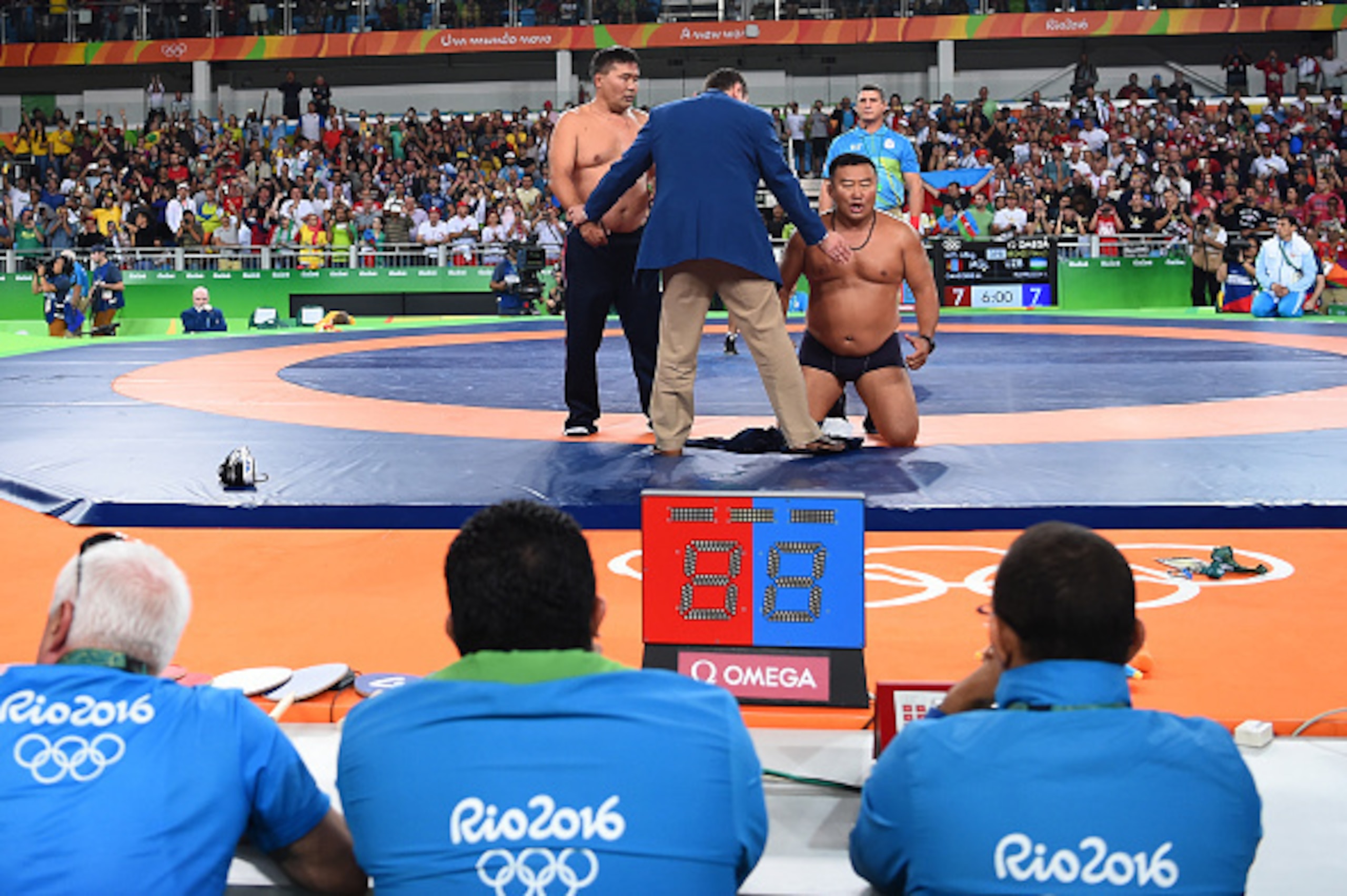 RIO DE JANEIRO, BRAZIL - AUGUST 21:  Mongolias coaches protest the judges decision after Mandakhnaran Ganzorig (red) of Mongolia is defeated by Ikhtiyor Navruzov (blue) of Uzbekistan in the Men's Freestyle 65kg Bronze match against  on Day 16 of the Rio 2