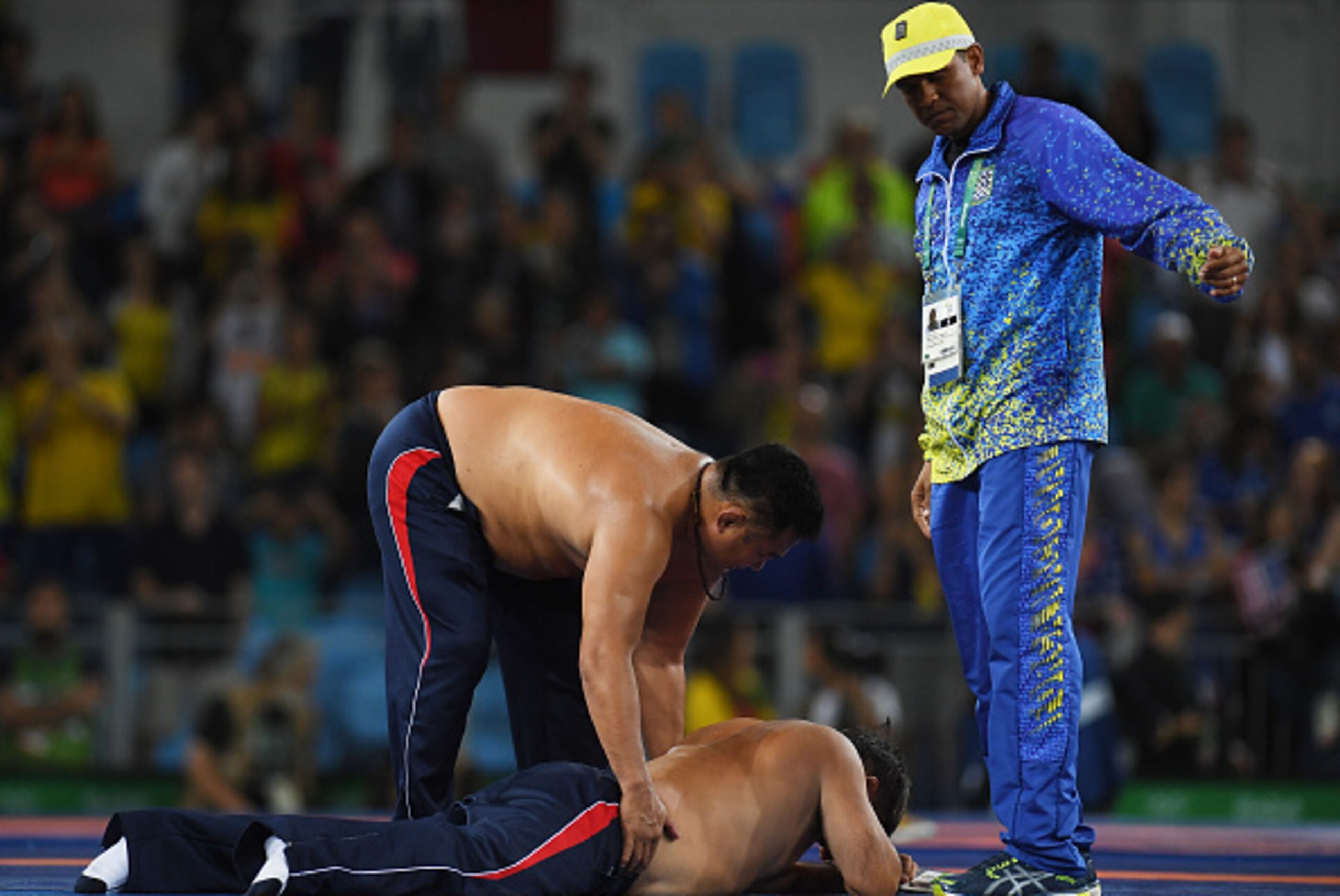 RIO DE JANEIRO, BRAZIL - AUGUST 21:  Mongolias coaches protest the judges decision after Mandakhnaran Ganzorig (red) of Mongolia is defeated by Ikhtiyor Navruzov (blue) of Uzbekistan in the Men's Freestyle 65kg Bronze match against  on Day 16 of the Rio 2