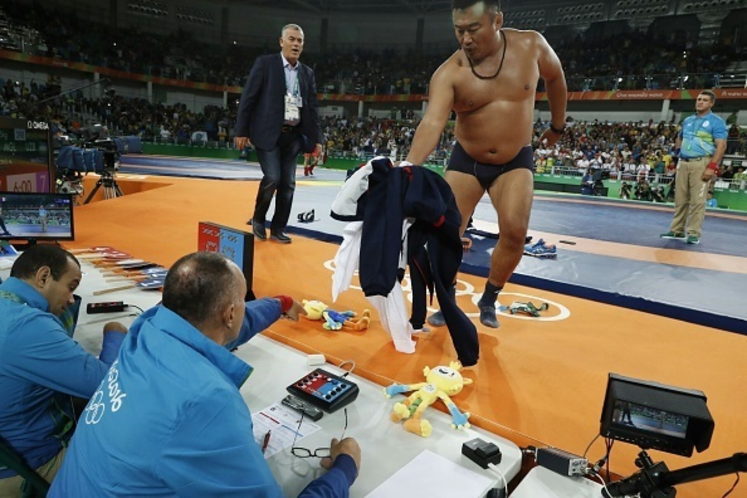 Mongolia's Mandakhnaran Ganzorig's coach reacts after the judges announced that Uzbekistan's Ikhtiyor Navruzov won folling a video replay in their men's 65kg freestyle bronze medal match on August 21, 2016, during the wrestling event of the Rio 2016 Olymp