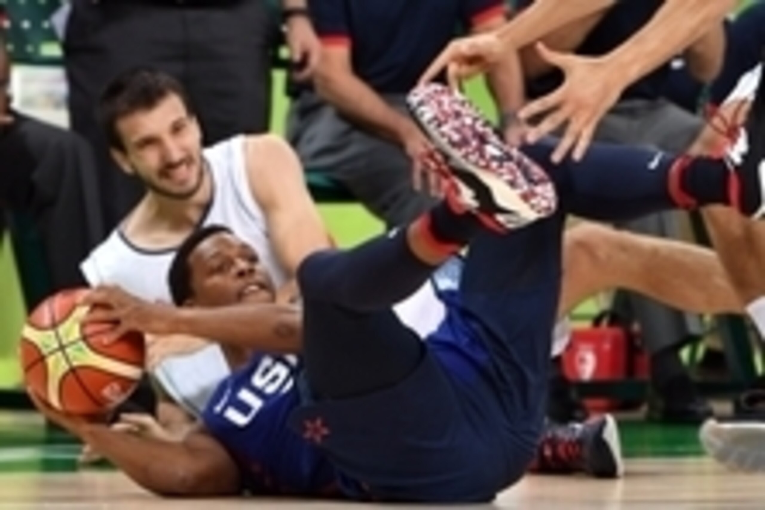 Aug 21, 2016; Rio de Janeiro, Brazil; USA guard Kyle Lowry (7) picks up a loose ball against Serbia in the men's basketball gold medal match during the Rio 2016 Summer Olympic Games at Carioca Arena 1. Mandatory Credit: Bob Rosato-USA TODAY Sports