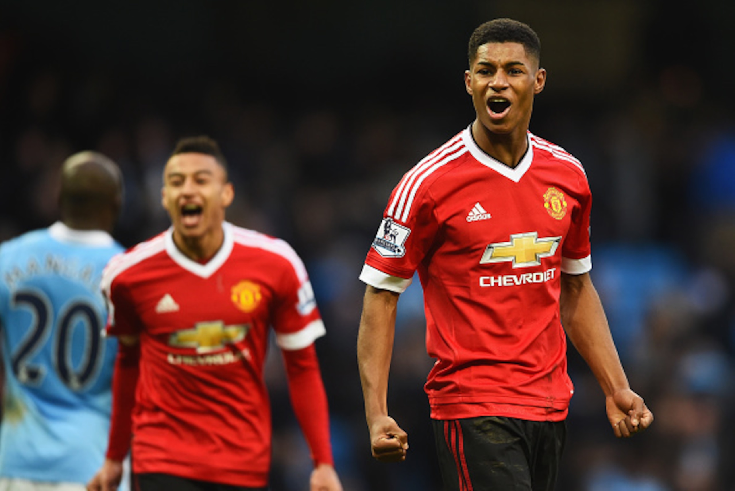 MANCHESTER, ENGLAND - MARCH 20:  Winning goalscorer Marcus Rashford of Manchester United (R) and team mate Jesse Lingard celebrate victory after the Barclays Premier League match between Manchester City and Manchester United at Etihad Stadium on March 20,