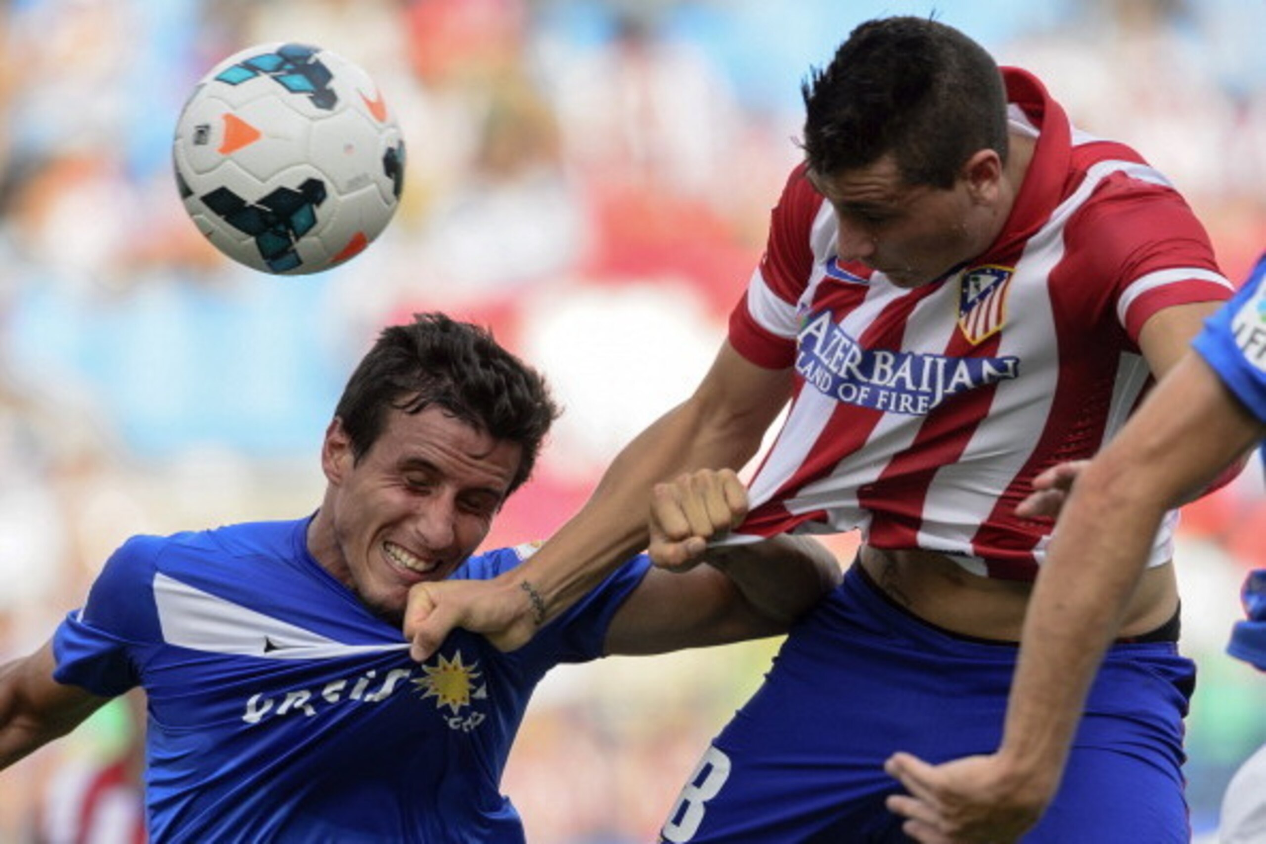 Atletico Madrid's Uruguayan defender Jose Maria Gimenez de Vargas (R) heads the ball during the Spanish league football match Club Atletico de Madrid vs UD Almeria at the Vicente Calderon stadium in Madrid on September 14, 2013.   AFP PHOTO/ DANI POZO    