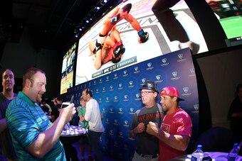LAS VEGAS, NV - JULY 7: Urijah Faber poses for a photo with a fan during the UFC Topgolf Challenge at Topgolf Las Vegas on July 7, 2016 in Las Vegas, Nevada. (Photo by Rey Del Rio/Zuffa LLC/Zuffa LLC via Getty Images)