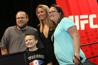LAS VEGAS, NV - JULY 08:  UFC's Paige VanZant (C) poses with a family of UFC fans during day 1 of the UFC Fan Expo at the Las Vegas Convention Center on July 8, 2016 in Las Vegas, Nevada. (Photo by Ed Mulholland/Zuffa LLC/Zuffa LLC via Getty Images)