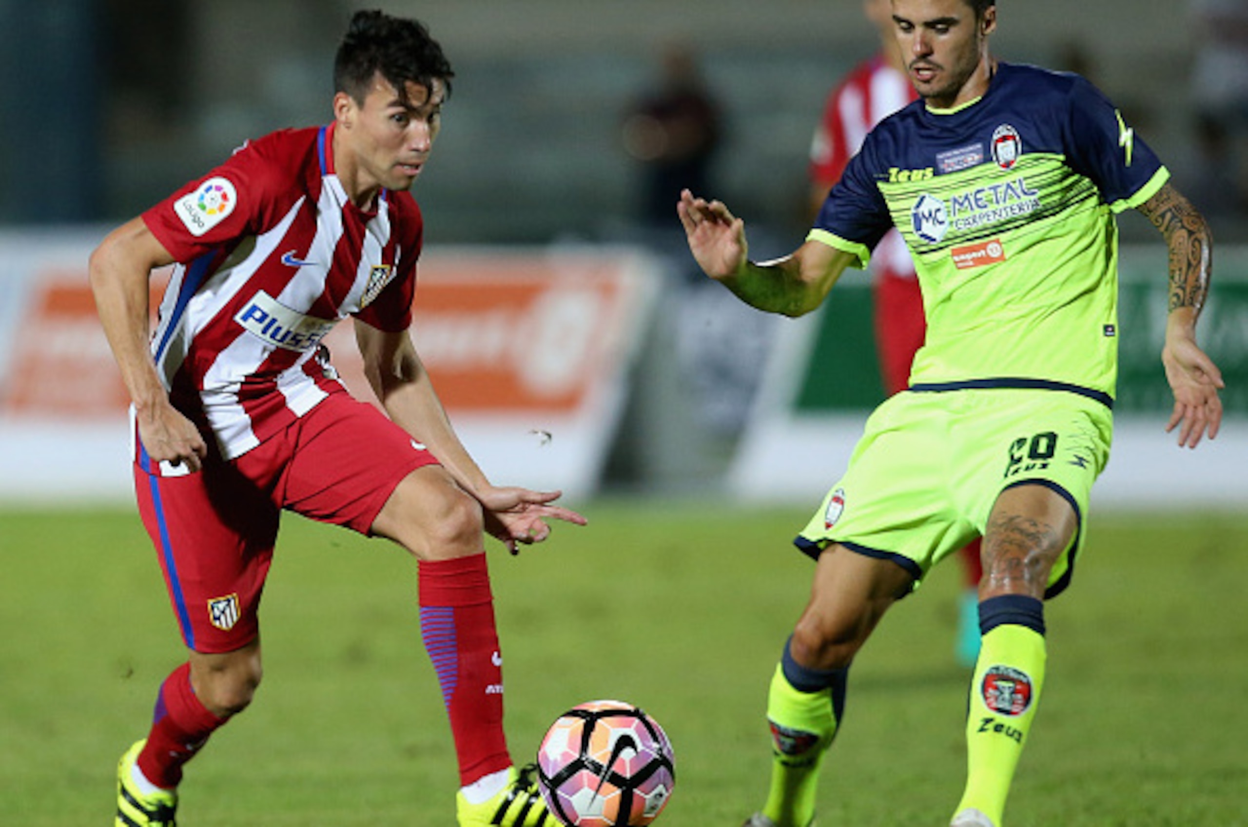 COSENZA, ITALY - AUGUST 06:  Aniello Salsano (R) of Crotone competes for the ball with Nico Gaitan of Atletico de Madrid during pres-season friendly match between FC Crotone and Club Atletico de Madrid at Stadio Comunale Gigi Marulla on August 6, 2016 in 
