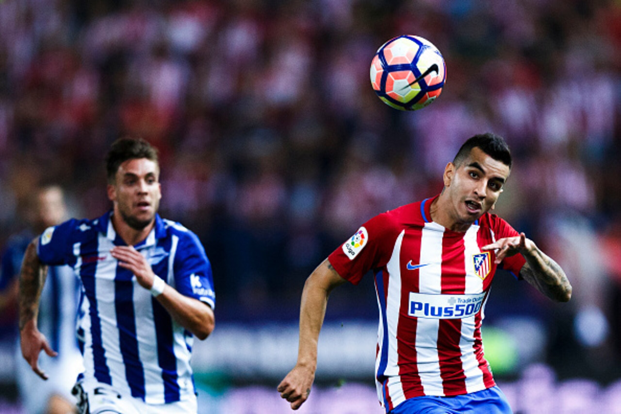 MADRID, SPAIN - AUGUST 21: Angel Martin Correa (R) of Atletico de Madrid competes for the ball with Kiko Femenia (R) of Deportivo Alaves during the La Liga match between Club Atletico de Madrid and Deportivo Alaves at Vicente Calderon stadium on August 21