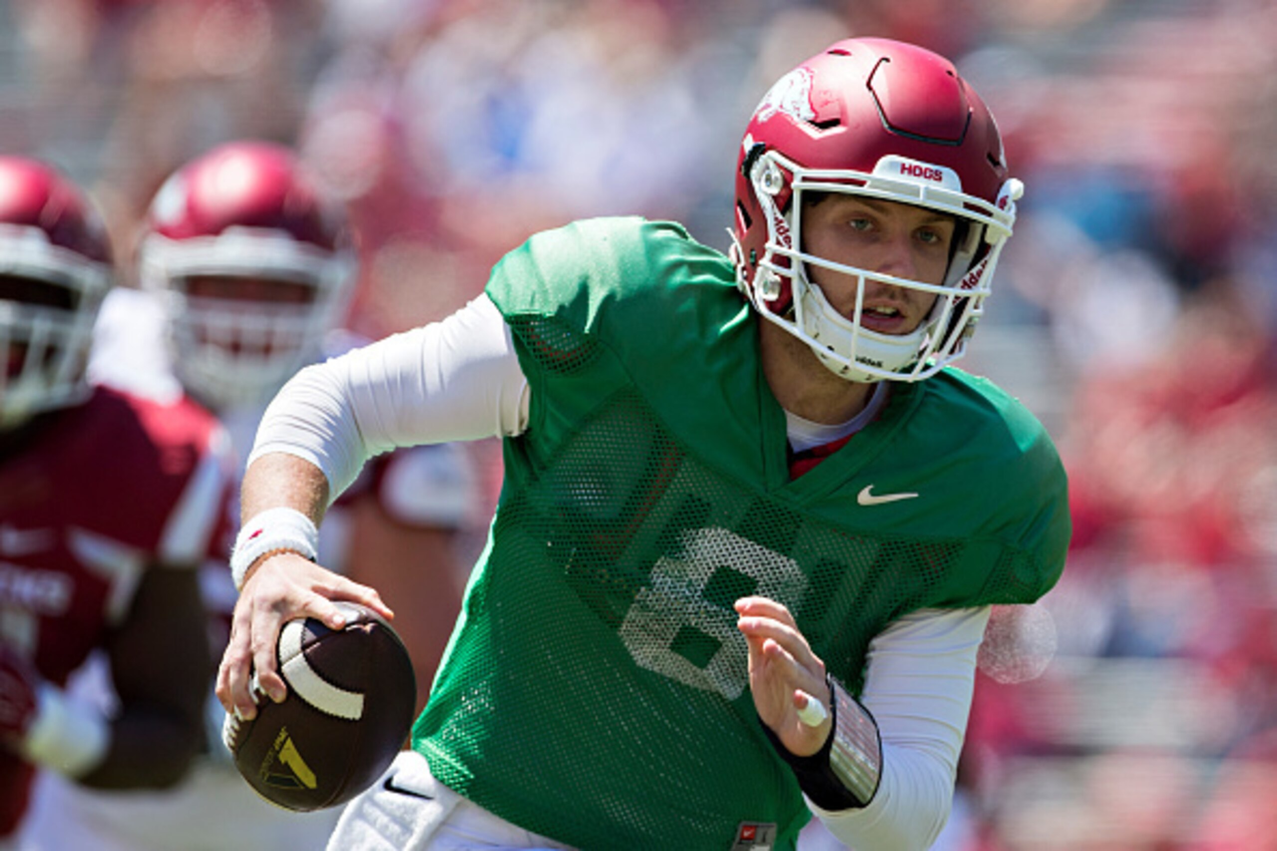 FAYETTEVILLE, AR - APRIL 23:  Quarterback Austin Allen #8 of the Arkansas Razorbacks White team rolls out looking for a receiver during the annual Razorback Red & White Spring Game at Donald W. Reynolds Razorback Stadium on April 23, 2016 in Fayetteville,