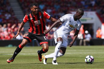 BOURNEMOUTH, ENGLAND - AUGUST 14: Eric Bailly (R) of Manchester United is tracked by Joshua King (L) of Bournemouth during the Premier League match between AFC Bournemouth and Manchester United at the Vitality Stadium on August 14, 2016 in Bournemouth, En