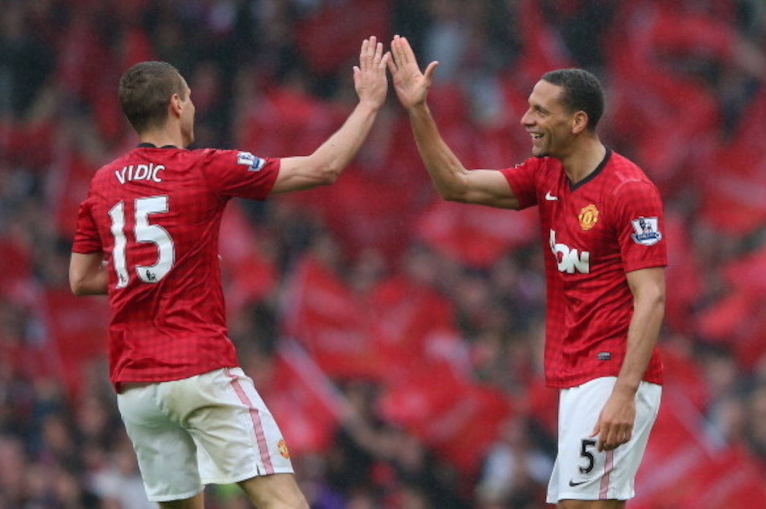 MANCHESTER, ENGLAND - MAY 12:  Rio Ferdinand of Manchester United celebrates scoring the winning goal with team-mate Nemanja Vidic during the Barclays Premier League match between Manchester United and Swansea City at Old Trafford on May 12, 2013 in Manch