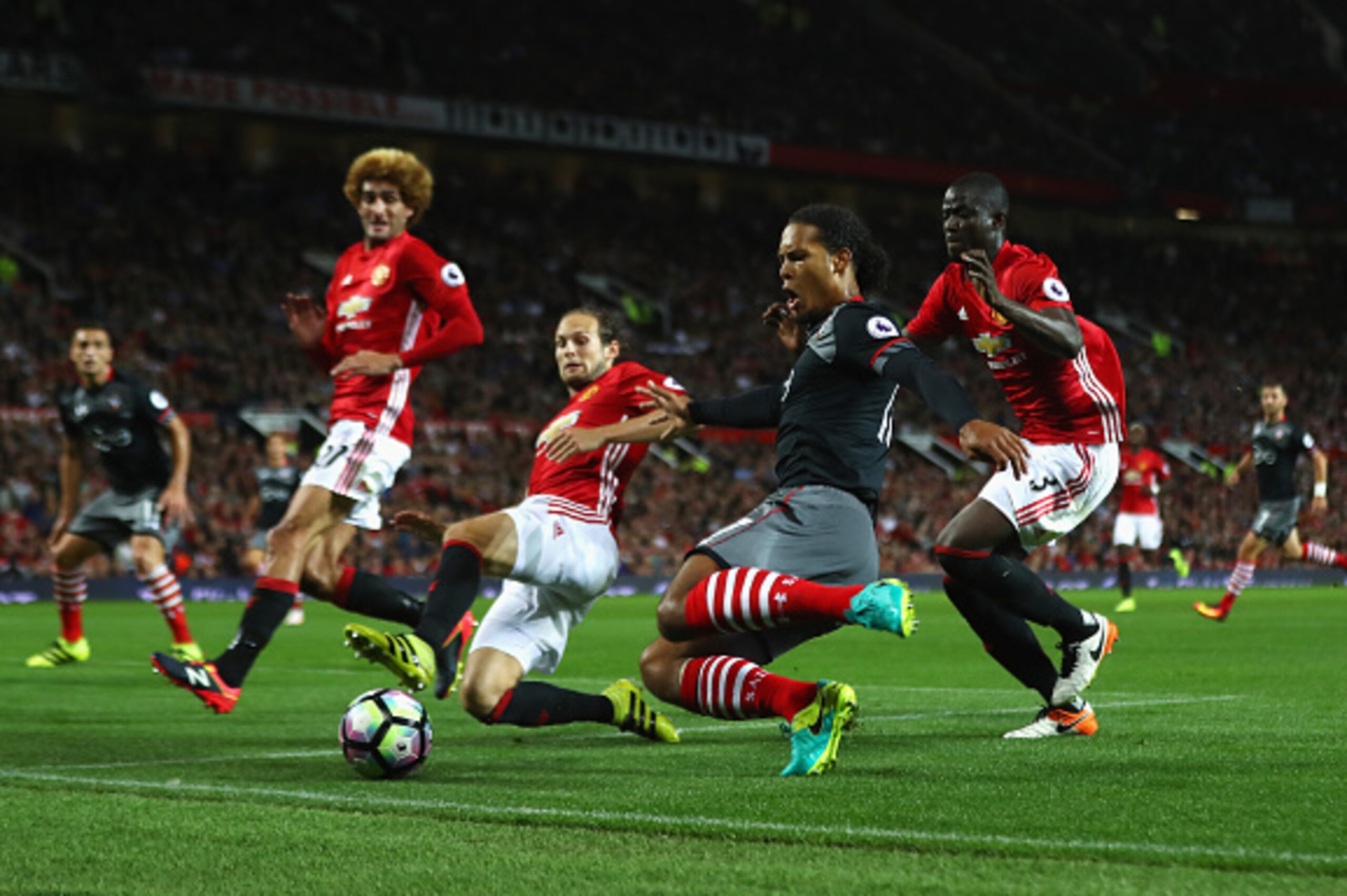 MANCHESTER, ENGLAND - AUGUST 19: Virgil van Dijk of Southampton is closed down by Daley Blind and Eric Bailly of Manchester United during the Premier League match between Manchester United and Southampton at Old Trafford on August 19, 2016 in Manchester, 