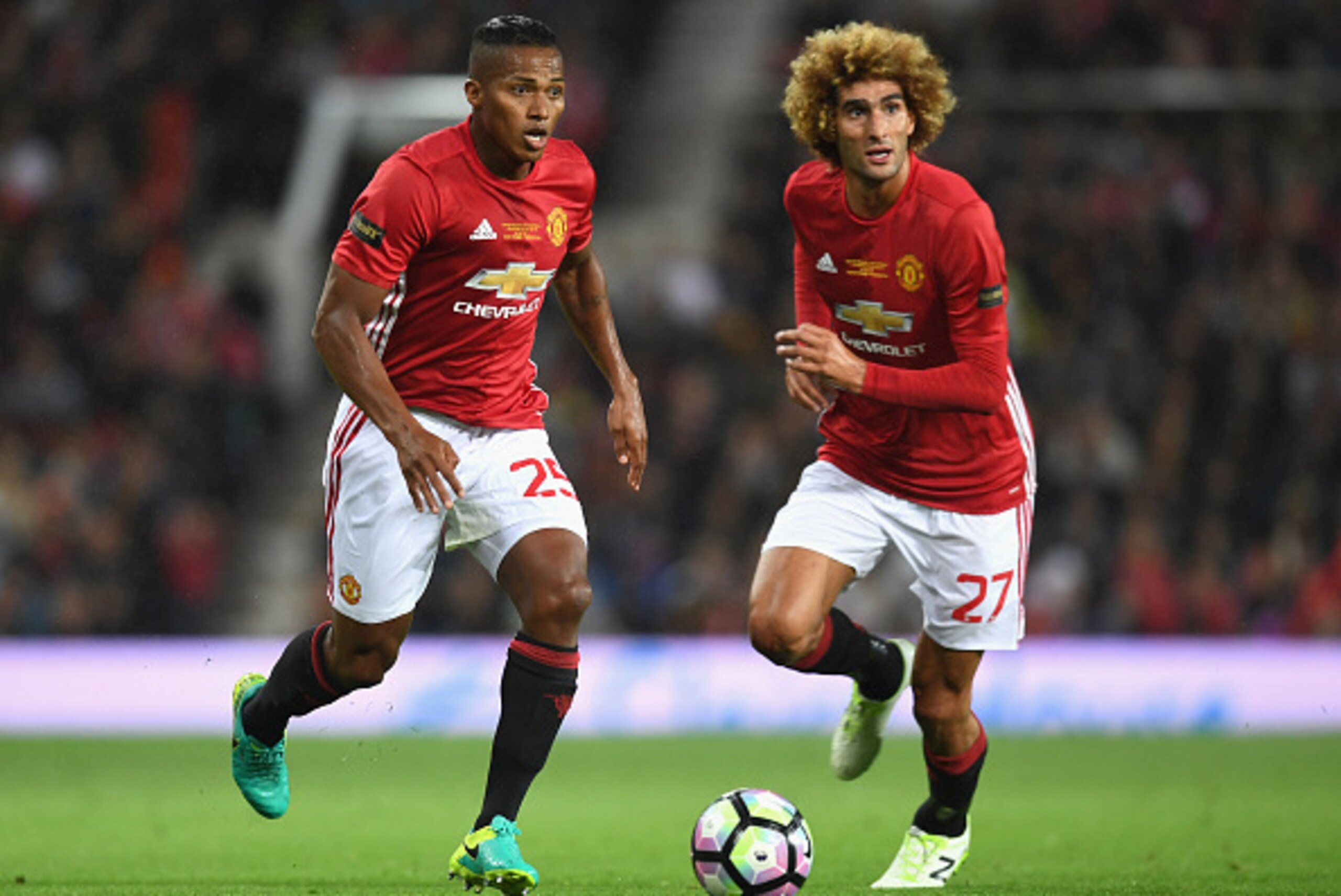 MANCHESTER, ENGLAND - AUGUST 03: Antonio Valencia of Manchester United and Marouane Fellaini of Manchester United in action during the Wayne Rooney Testimonial match between Manchester United and Everton at Old Trafford on August 3, 2016 in Manchester, En