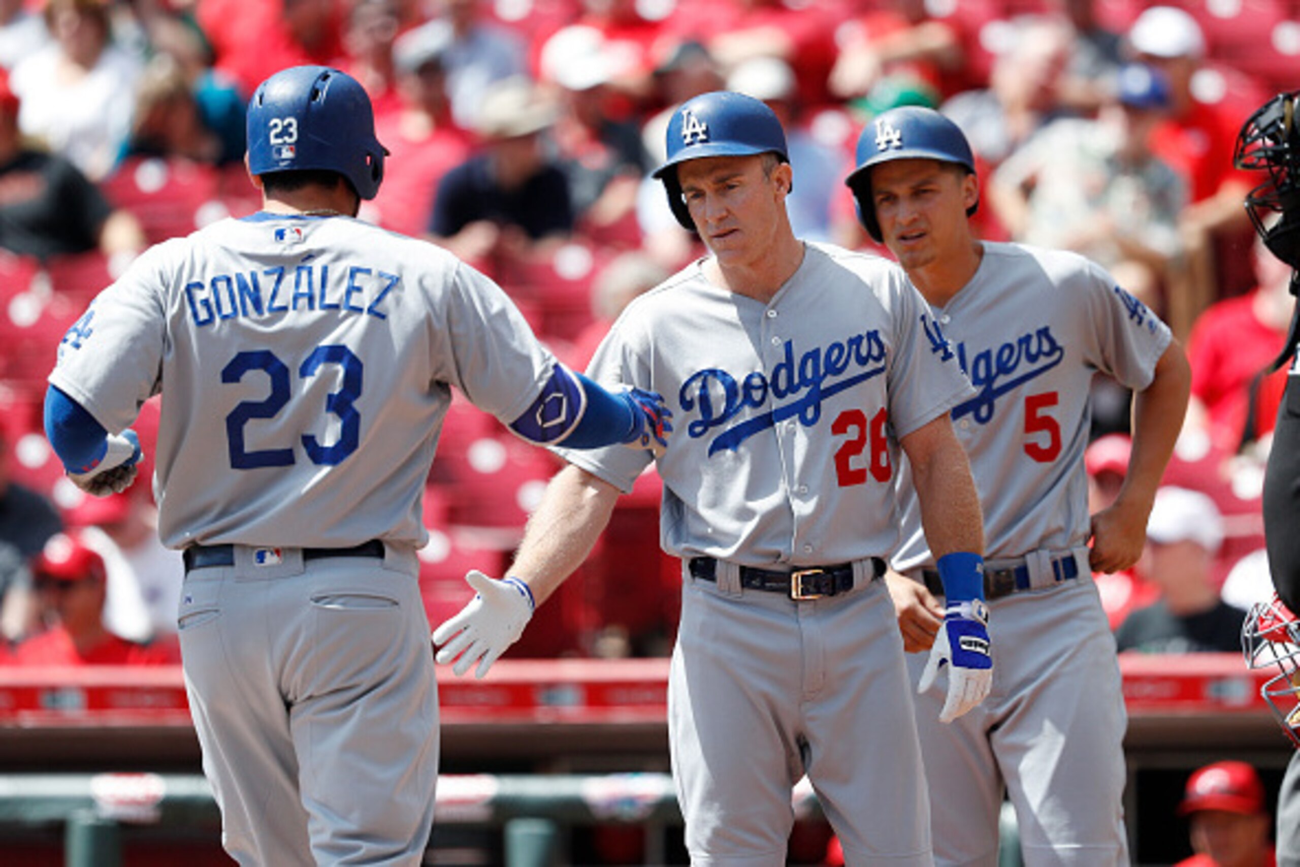 CINCINNATI, OH - AUGUST 22: Adrian Gonzalez #23 of the Los Angeles Dodgers is congratulated by Chase Utley #26 after hitting a three-run home run against the Cincinnati Reds in the first inning at Great American Ball Park on August 22, 2016 in Cincinnati,