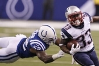 Oct 18, 2015; Indianapolis, IN, USA; New England Patriots running back Dion Lewis (33) runs past Indianapolis Colts inside linebacker D'Qwell Jackson (52) in the first half during the NFL game at Lucas Oil Stadium. Mandatory Credit: Brian Spurlock-USA TOD