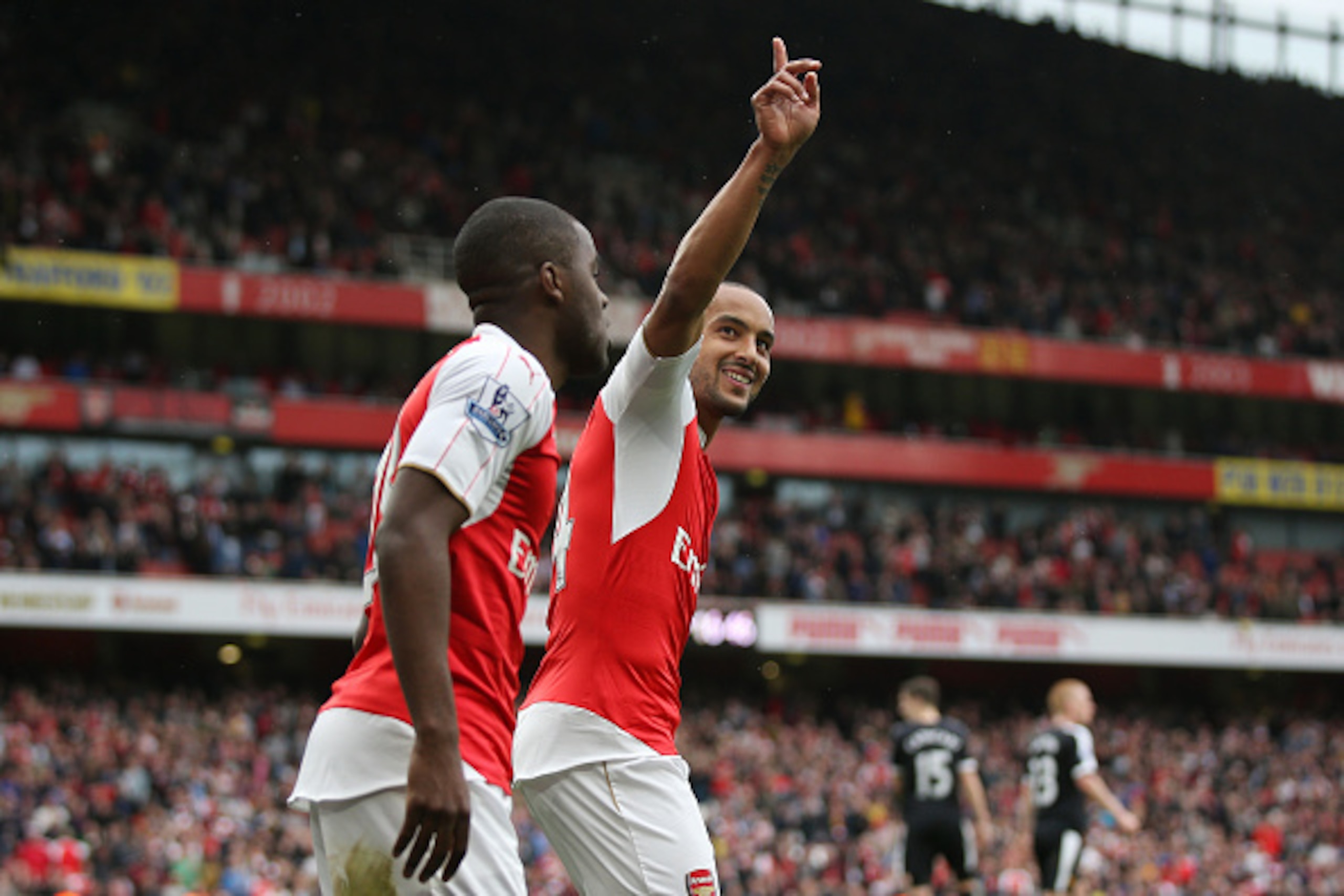 LONDON, ENGLAND - APRIL 02: Theo Walcott (R) of Arsenal celebrates scoring his team's fourth goal with his team mate Joel Campbell (L) during the Barclays Premier League match between Arsenal and Watford at Emirates Stadium on April 2, 2016 in London, Eng