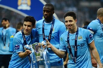 LONDON, ENGLAND - MARCH 02:  (L-R) Jesus Navas, Yaya Toure and Samir Nasri of Manchester City pose with the trophy after the Capital One Cup Final between Manchester City and Sunderland at Wembley Stadium on March 2, 2014 in London, England.  (Photo by Ja
