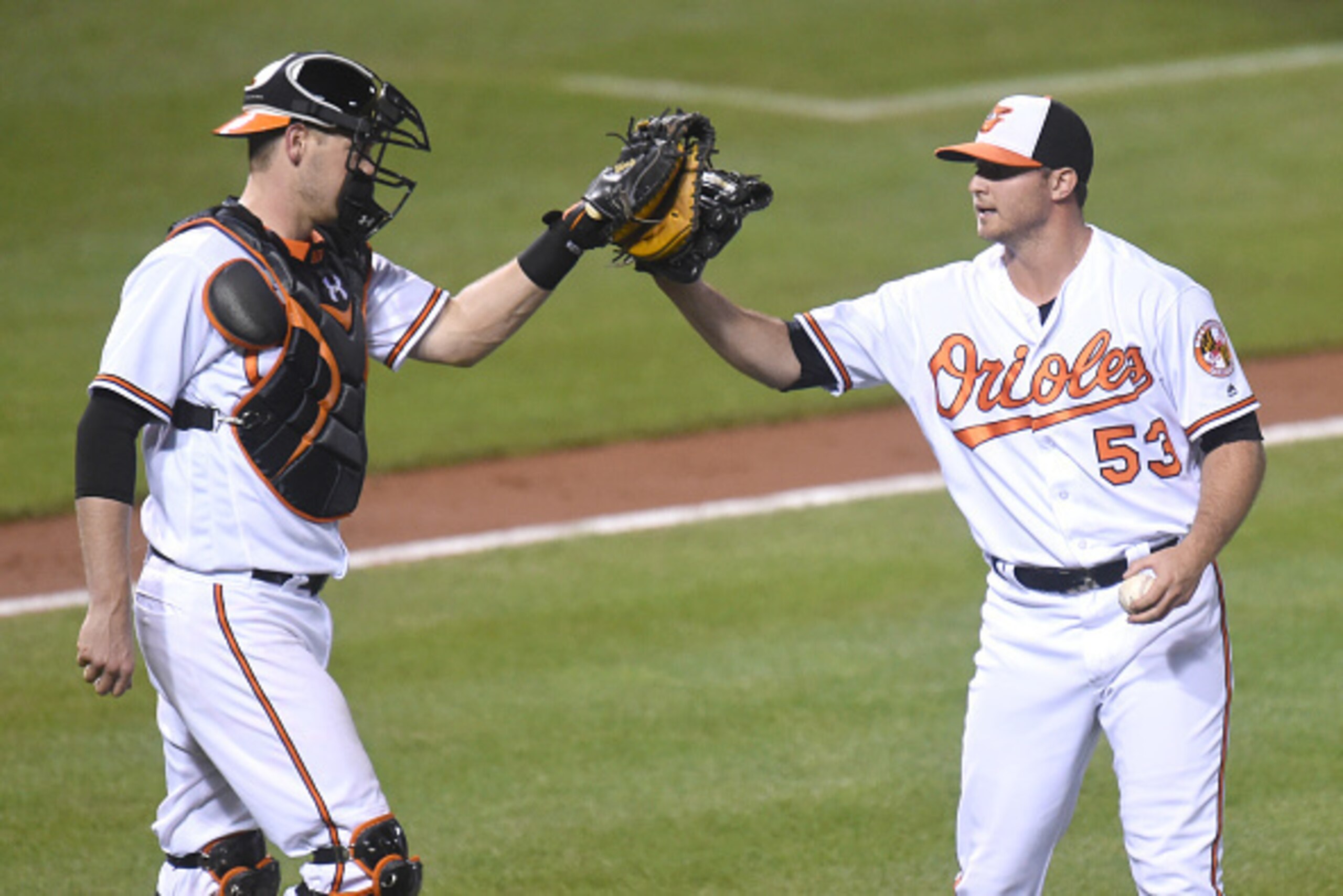 BALTIMORE, MD - AUGUST 22:  Matt Wieters #32 of the Baltimore Orioles celebrates a win with Zach Britton #53 after a baseball game against the the Washington Nationals at Oriole Park at Camden Yards on August 22, 2016 in Baltimore, Maryland.  The Oriole w