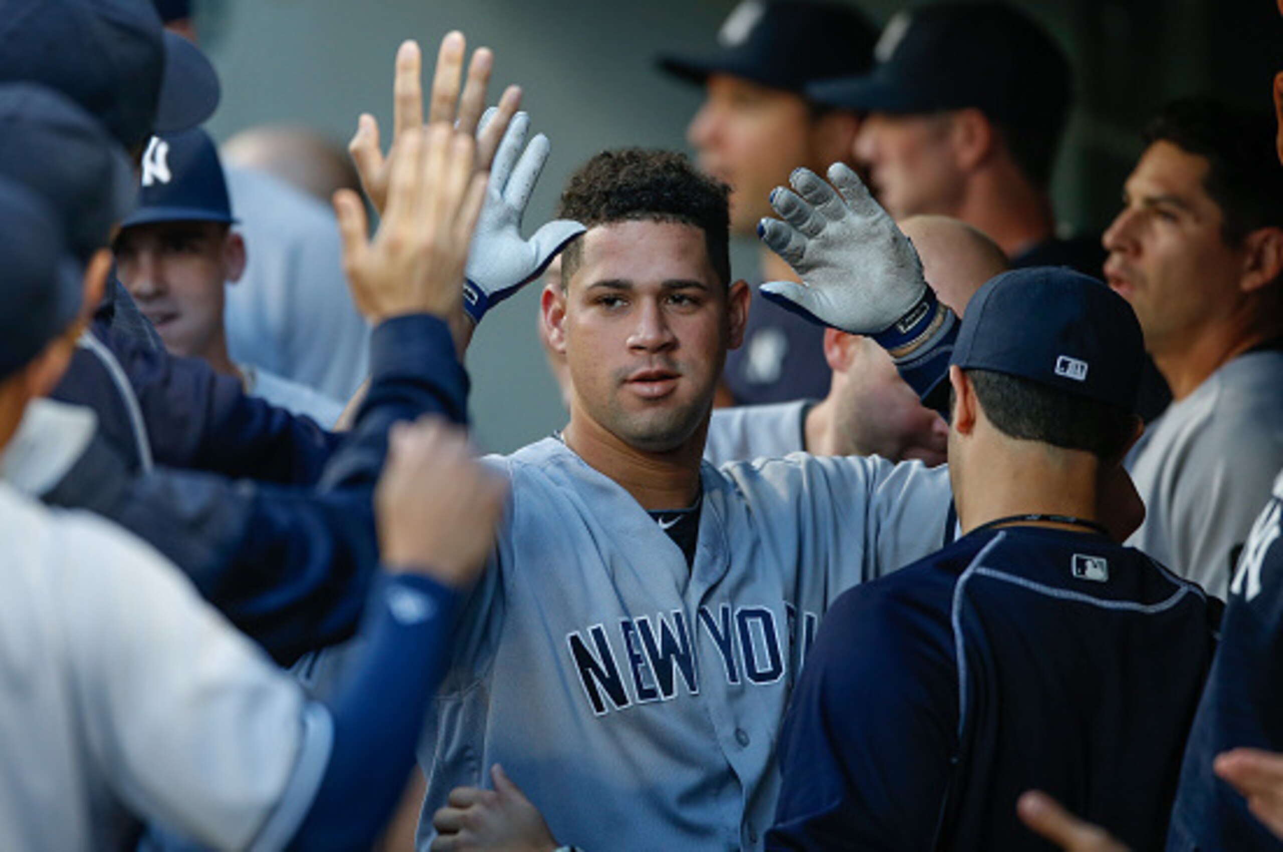 SEATTLE, WA - AUGUST 22:  Gary Sanchez #24 of the New York Yankees is congratulated by teammates after hitting a home run against the Seattle Mariners in the first inning at Safeco Field on August 22, 2016 in Seattle, Washington.  (Photo by Otto Greule Jr