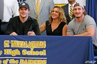 John (far left), Nick (left), Cheryl (center) and Joey (right) on Nick's signing day in February.