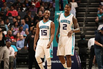 CHARLOTTE, NC - APRIL 13:  Kemba Walker #15 and Marvin Williams #2 of the Charlotte Hornets smile during the game against the Houston Rockets at the Time Warner Cable Arena on April 13, 2015 in Charlotte, North Carolina. NOTE TO USER: User expressly ackno