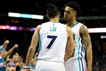 CHARLOTTE, NC - APRIL 25:  Teammates Courtney Lee #1 and Jeremy Lin #7 of the Charlotte Hornets react after a play against the Miami Heat during game four of the Eastern Conference Quarterfinals of the 2016 NBA Playoffs at Time Warner Cable Arena on April