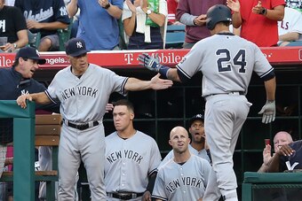 ANAHEIM, CALIFORNIA - AUGUST 20: Gary Sanchez #24 of the New York Yankees is greeted by manager Joe Girardi as he returns to the dugout after hitting a solo home run in the first inning against the Los Angeles Angels of Anaheim at Angel Stadium of Anaheim