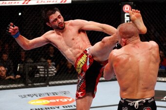 MONTREAL, QC - NOVEMBER 17:  Carlos Condit lands a left footed kick to the head of Georges St-Pierre in their welterweight title bout during UFC 154 on November 17, 2012  at the Bell Centre in Montreal, Canada.  (Photo by Josh Hedges/Zuffa LLC/Zuffa LLC v