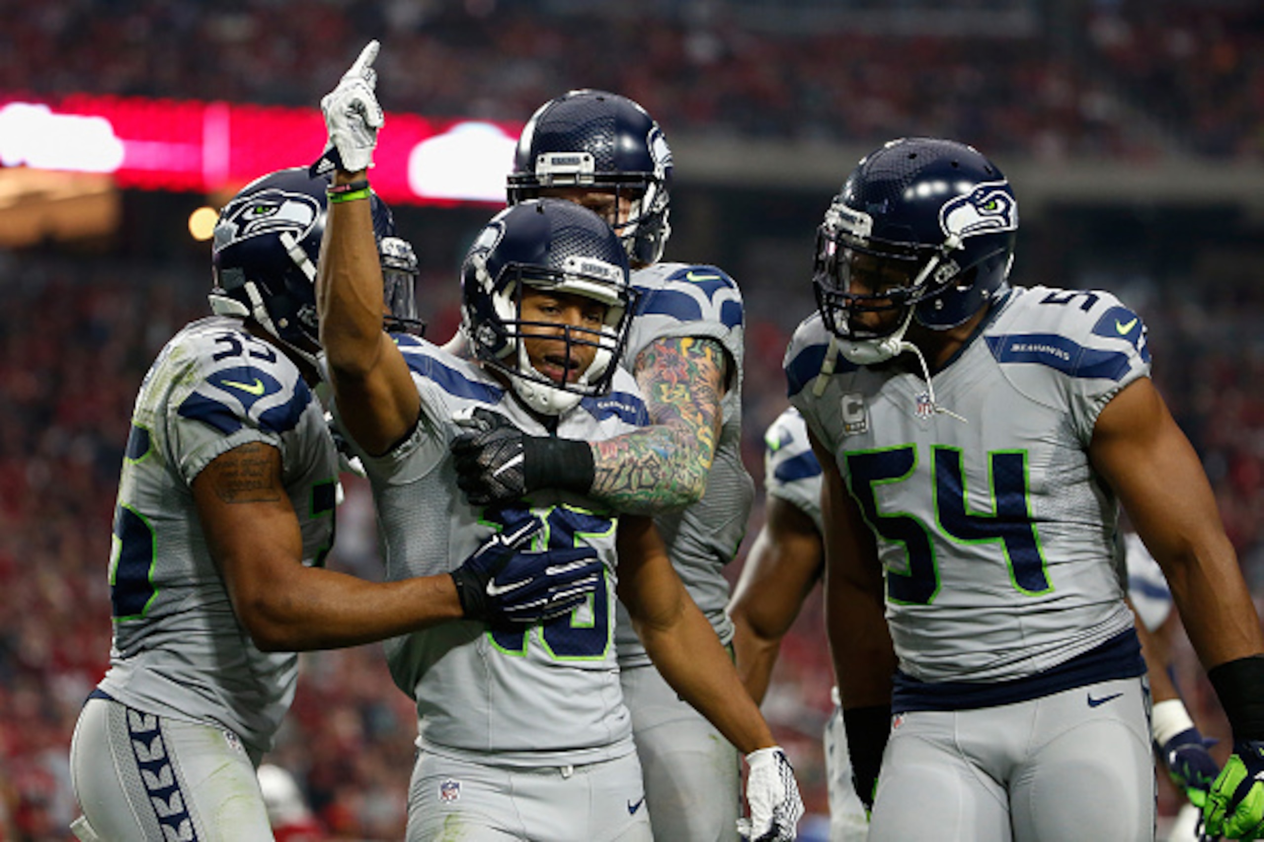 GLENDALE, AZ - JANUARY 03:  Wide receiver Tyler Lockett #16 of the Seattle Seahawks is congratulated by DeShawn Shead #35 and  Bobby Wagner #54 after a punt return against the Arizona Cardinals during the second quarter of the NFL game at the University o