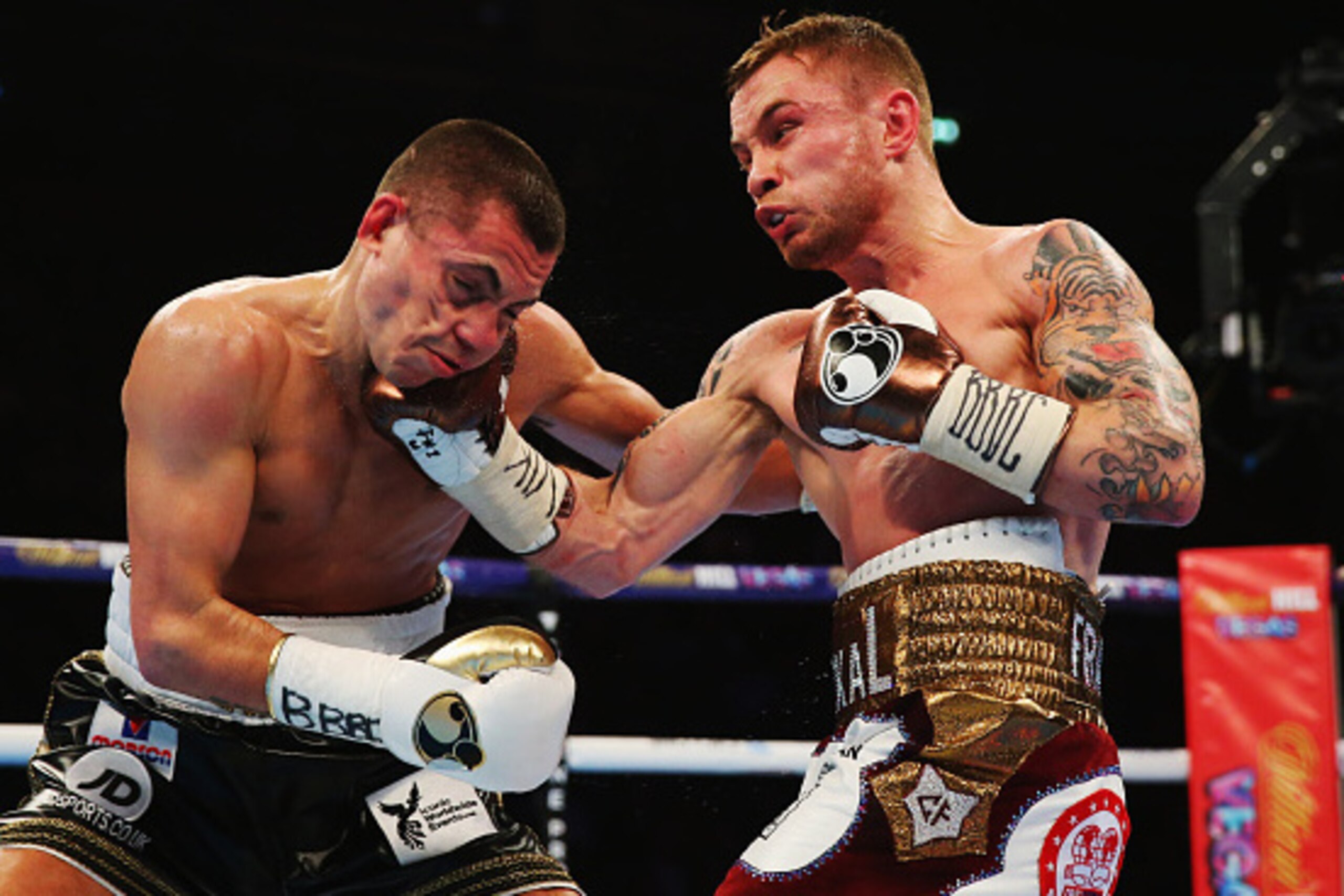 MANCHESTER, ENGLAND - FEBRUARY 27:  Carl Frampton (R) connects with a punch on Scott Quigg during their World Super-Bantamweight title contest at Manchester Arena on February 27, 2016 in Manchester, England.  (Photo by Alex Livesey/Getty Images)
