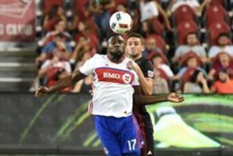 Jul 23, 2016; Toronto, Ontario, CAN; Toronto FC forward Jozy Altidore (17) heads the ball down in front of DC United defender Steven Birnbaum (15) at BMO Field. Mandatory Credit: Dan Hamilton-USA TODAY Sports