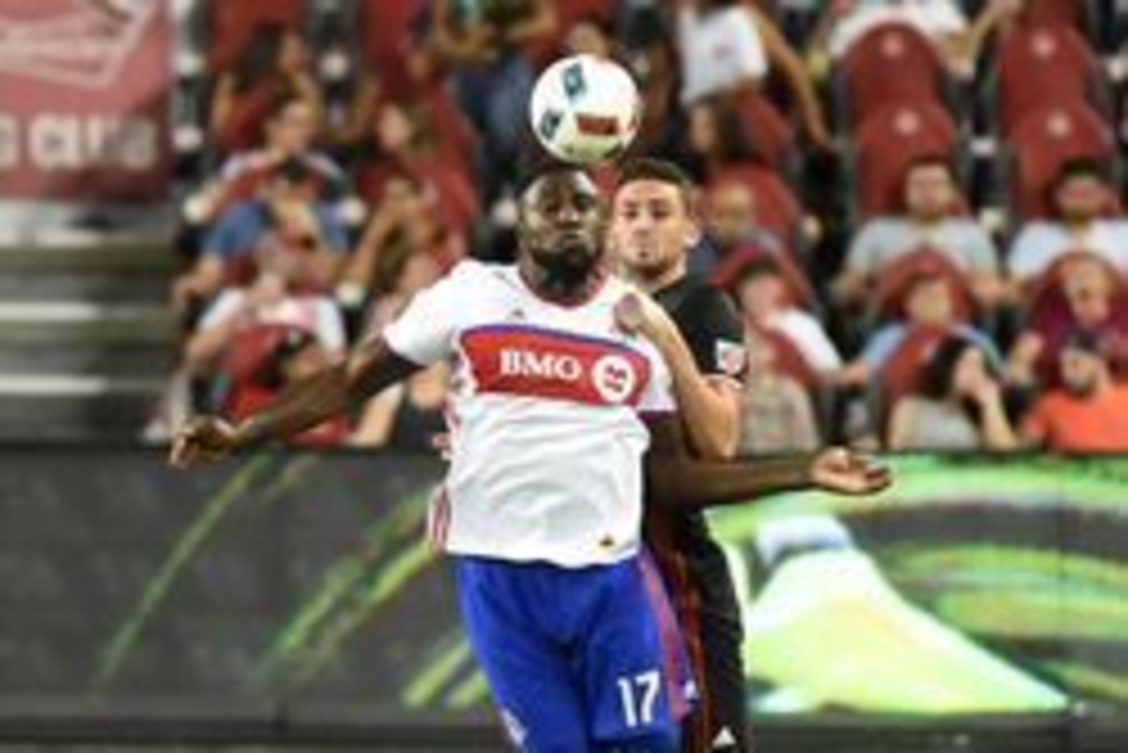 Jul 23, 2016; Toronto, Ontario, CAN; Toronto FC forward Jozy Altidore (17) heads the ball down in front of DC United defender Steven Birnbaum (15) at BMO Field. Mandatory Credit: Dan Hamilton-USA TODAY Sports