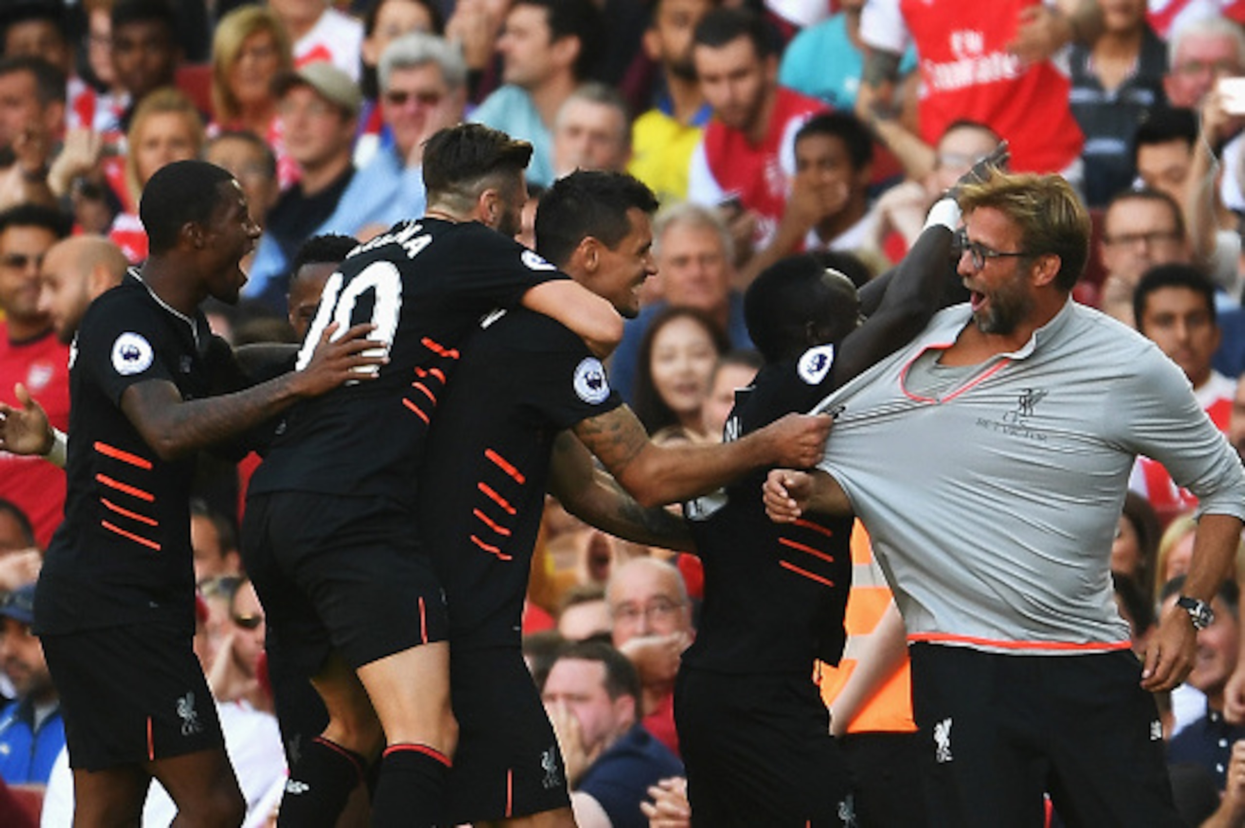 LONDON, ENGLAND - AUGUST 14: Sadio Mane of Liverpool and team mates celebrate his goal with Jurgen Klopp, Manager of Liverpool during the Premier League match between Arsenal and Liverpool at Emirates Stadium on August 14, 2016 in London, England. (Phot LONDON, ENGLAND - AUGUST 14: Sadio Mane of Liverpool and team mates celebrate his goal with Jurgen Klopp, Manager of Liverpool during the Premier League match between Arsenal and Liverpool at Emirates Stadium on August 14, 2016 in London, England. (Phot
