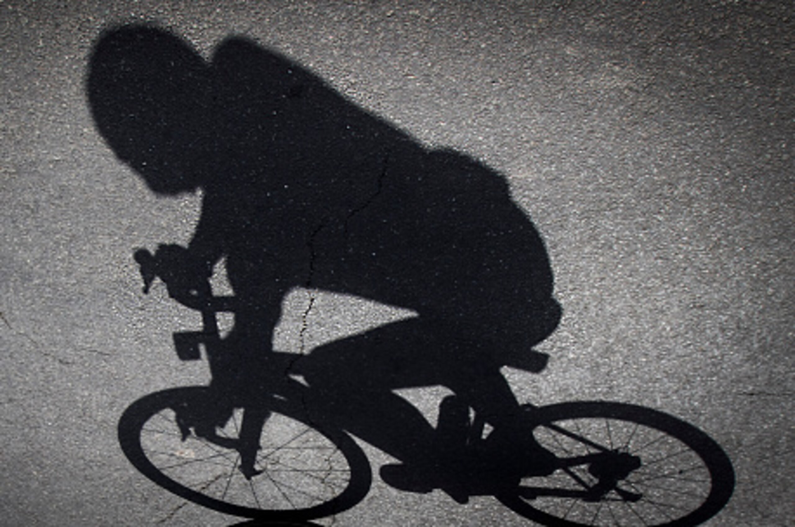 The shadow of a cyclist is projected on the ground prior to the 7th stage of the 71st edition of 'La Vuelta' Tour of Spain, a 158,5 km route between Maceda to Puebla de Sanabria on August 26, 2016. / AFP / JAIME REINA        (Photo credit should read JAIM