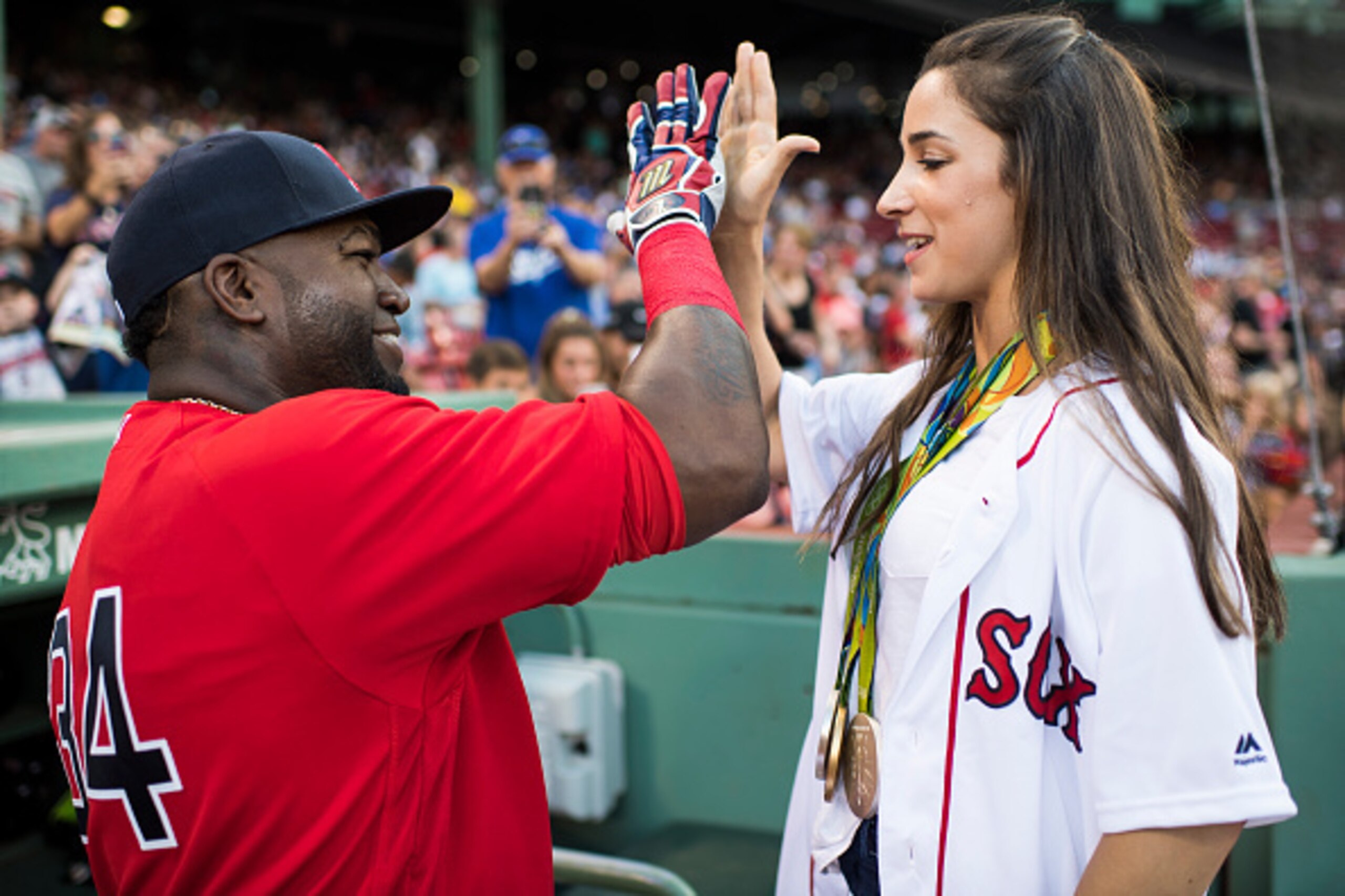 BOSTON, MA - AUGUST 26:  David Ortiz #34 of the Boston Red Sox greets Olympic gymnast Aly Raisman on August 26, 2016 at Fenway Park in Boston, Massachusetts. (Photo by Michael Ivins/Boston Red Sox/Getty Images)
