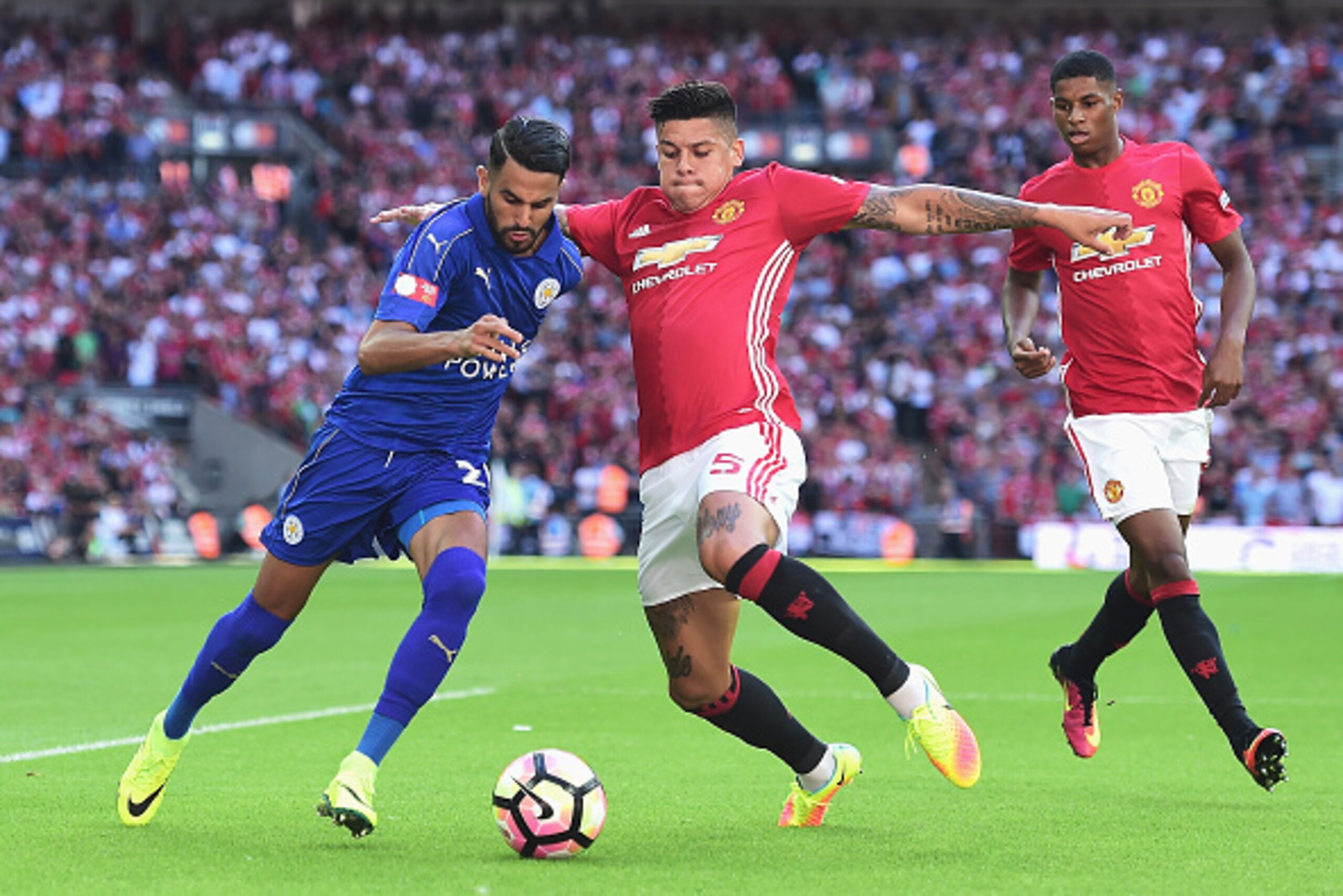 LONDON, ENGLAND - AUGUST 07: Marcos Rojo of Manchester United attempts to tackle Riyad Mahrez of Leicester City during The FA Community Shield match between Leicester City and Manchester United at Wembley Stadium on August 7, 2016 in London, England.  (Ph
