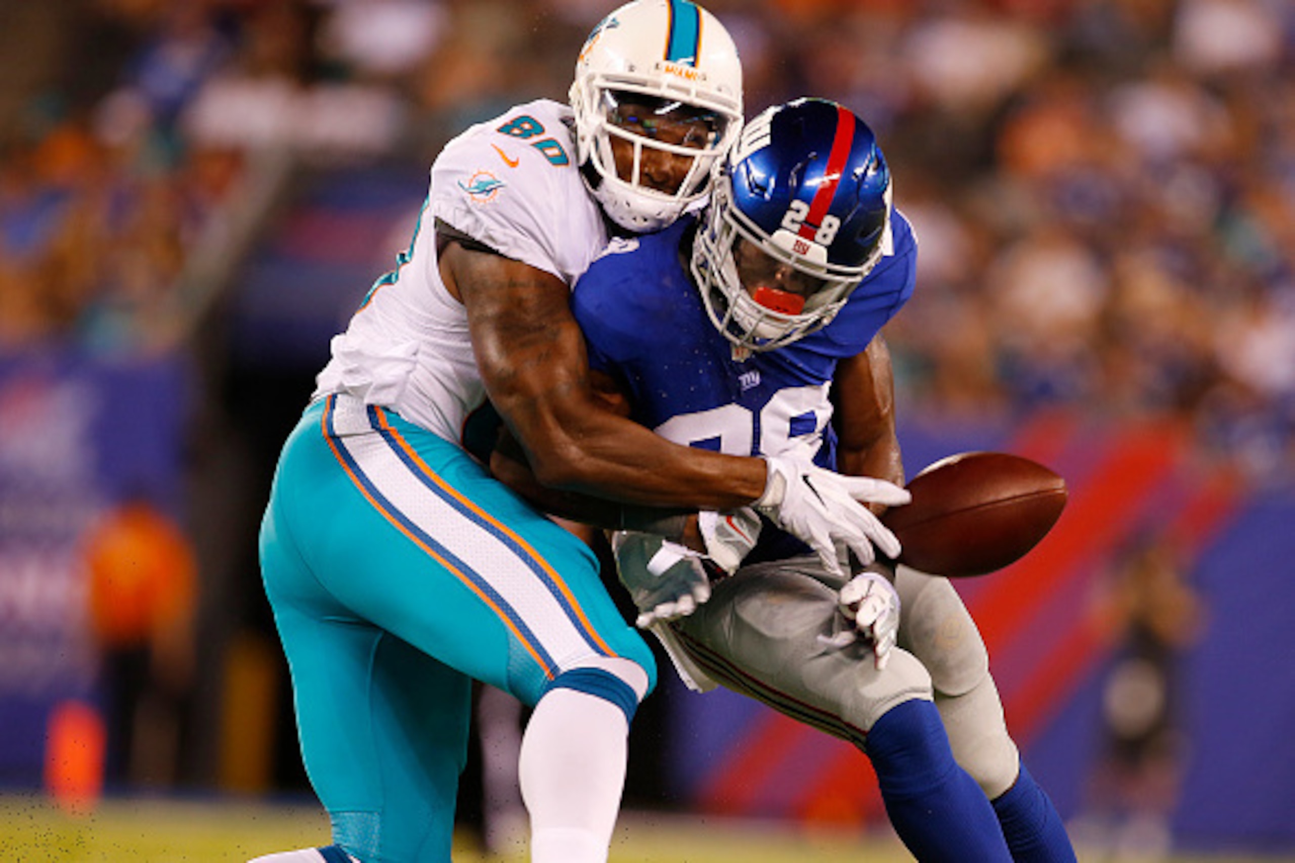 EAST RUTHERFORD, NJ - AUGUST 12: Eli Apple #28 of the New York Giants breaks up a pass intended for Dion Sims #80 of the Miami Dolphins during the first half of an NFL preseason game at MetLife Stadium on August 12, 2016 in East Rutherford, New Jersey. Th